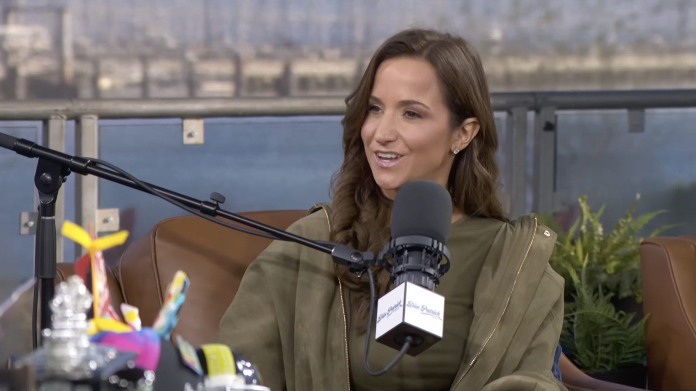 A screenshot of Dianna Russini when she appeared on the Dan Patrick show. She's sitting in a chair and talking into a microphone