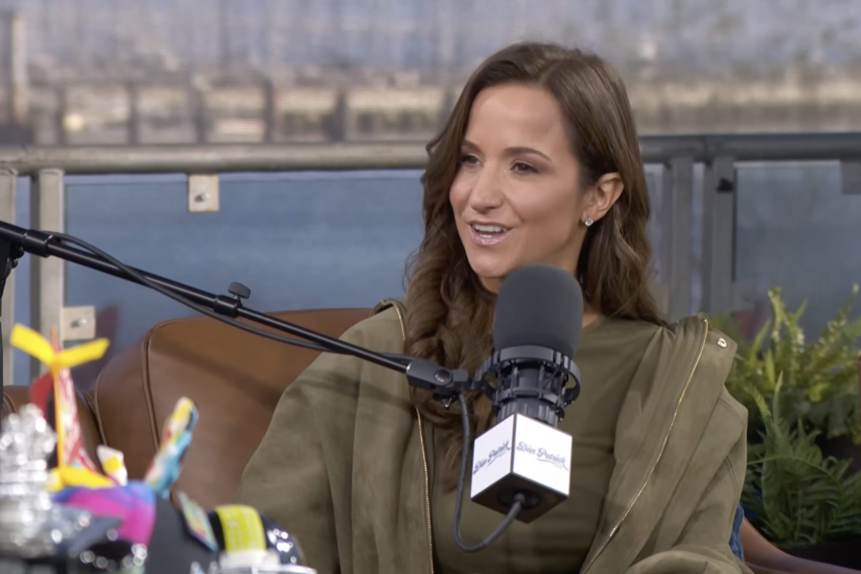 A screenshot of Dianna Russini when she appeared on the Dan Patrick show. She's sitting in a chair and talking into a microphone