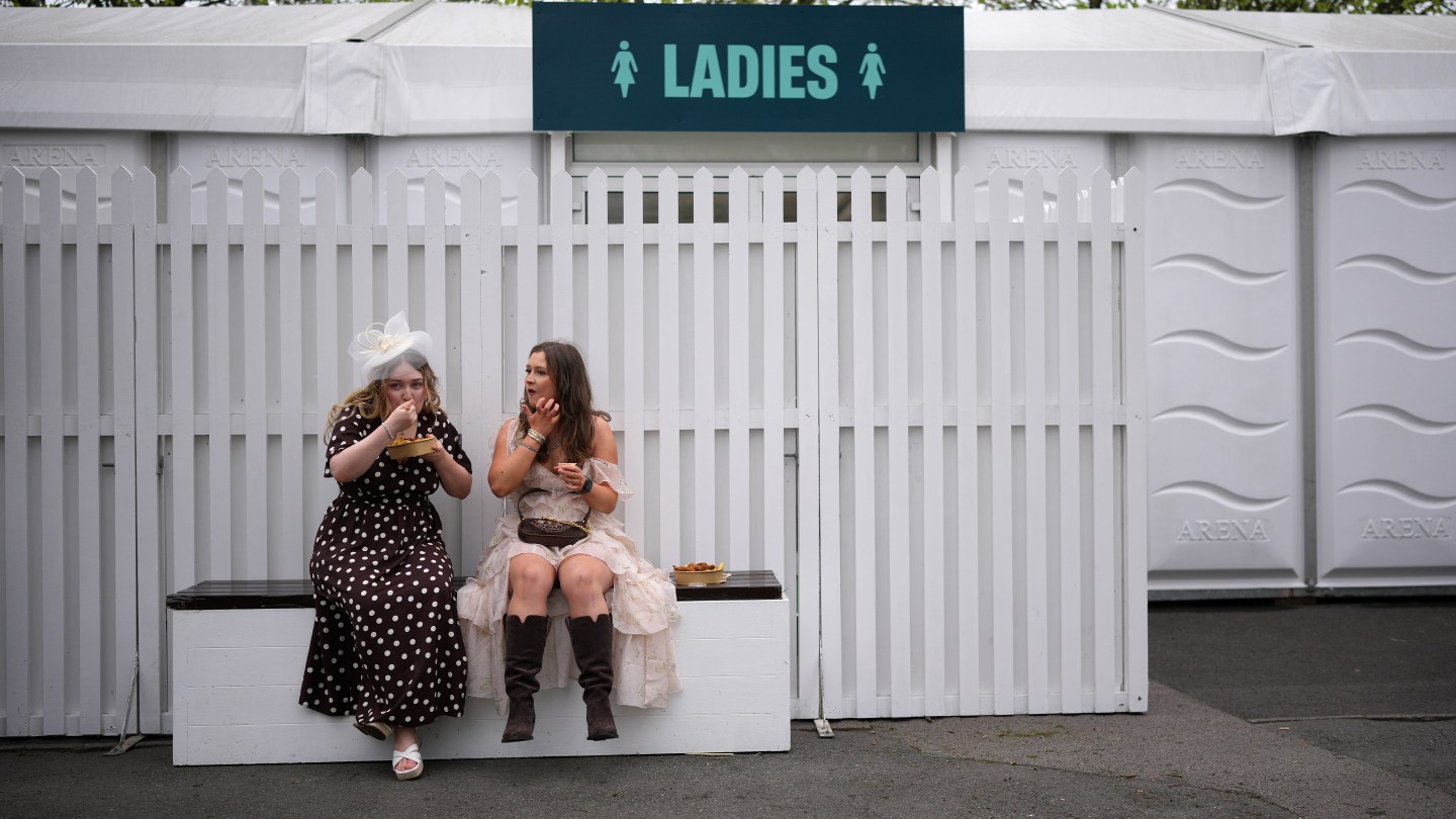 Racegoers arrive at Aintree for the first day of the Grand National Festival.