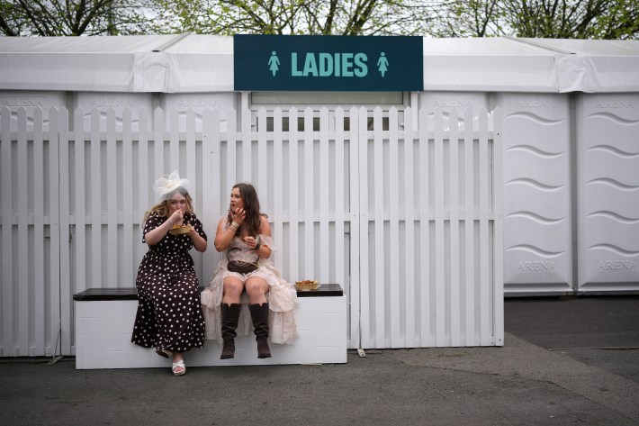 Racegoers arrive at Aintree for the first day of the Grand National Festival.