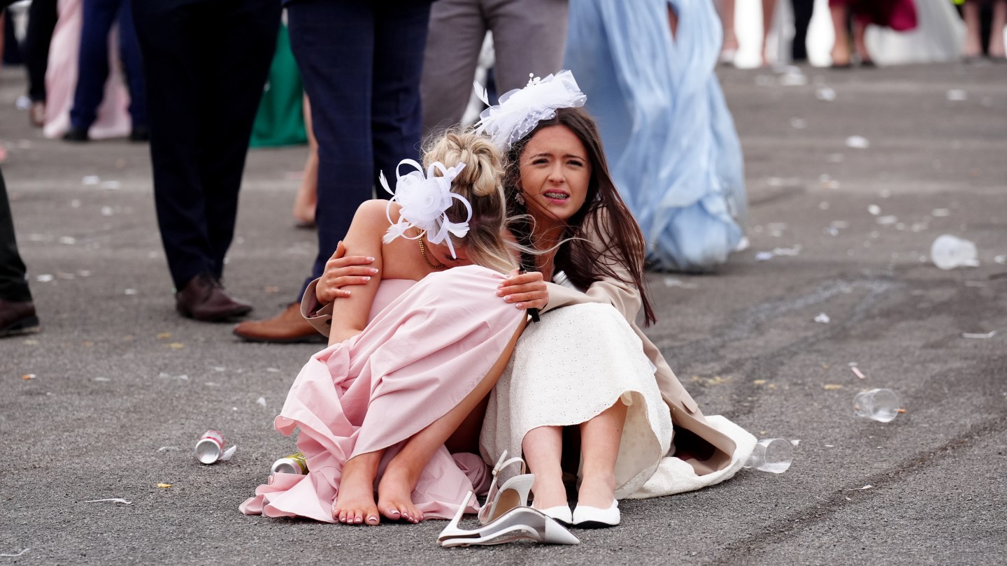 Racegoers at the end of Ladies Day of the Randox Grand National Festival 2026 at Aintree Racecourse.