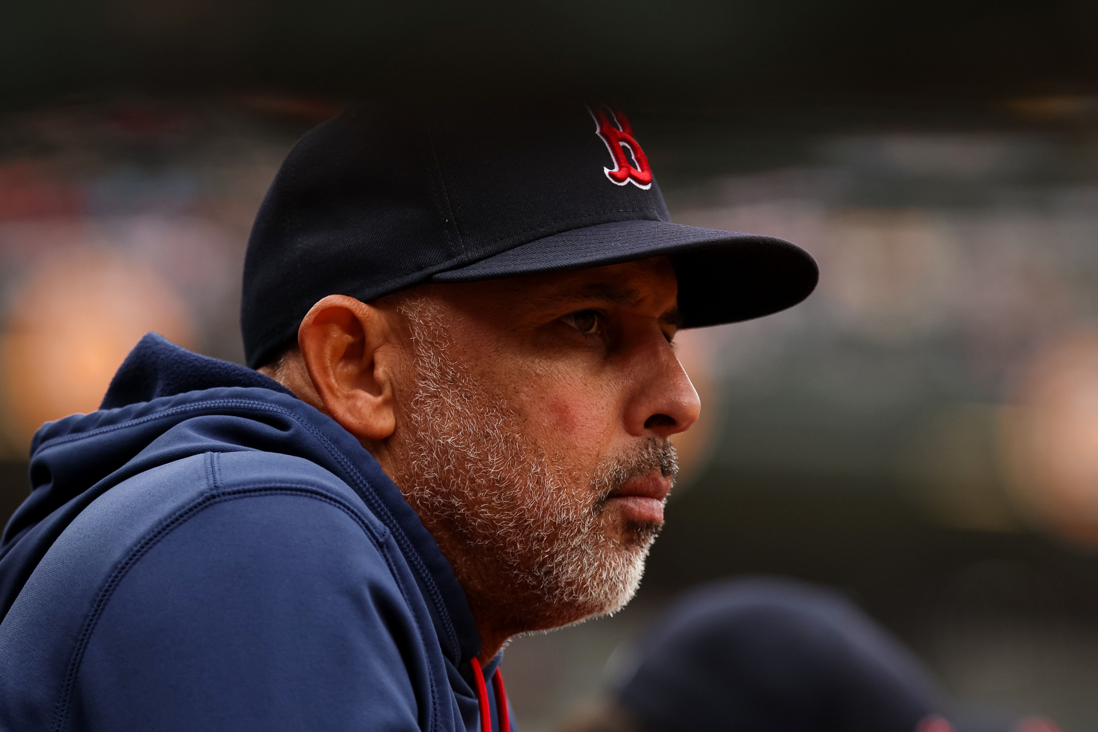 Manager Alex Cora #13 of the Boston Red Sox looks on from the dugout.