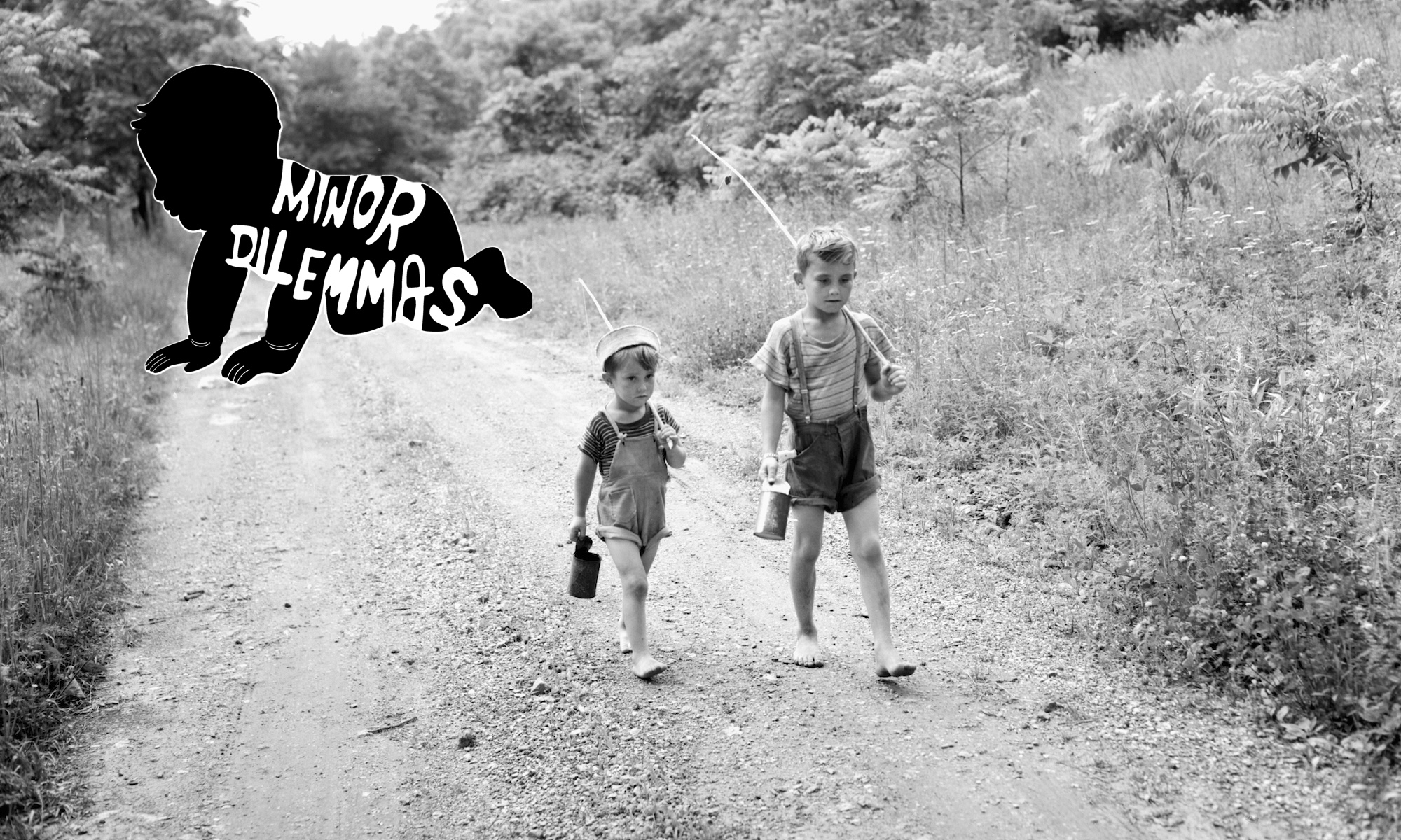 Two boys with fishing poles and cans of worms walk along a rural gravel road.