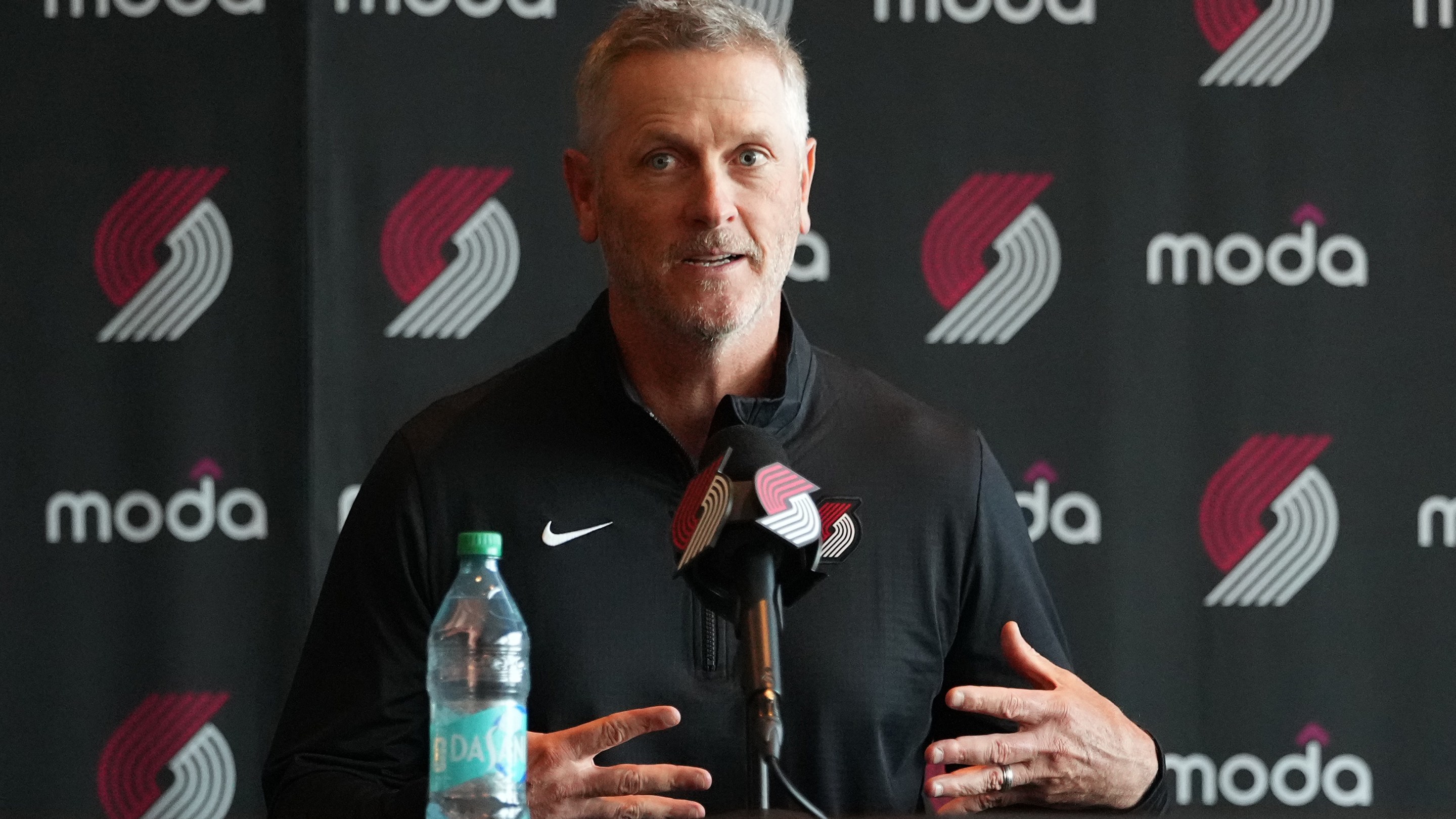 Tom Dundon, Portland Trail Blazers owner (C), speaks as alternate governors Sheel Tyle (L) and Andrew Cherng (R) listen during a press conference before a game against the New Orleans Pelicans at Moda Center on April 02, 2026 in Portland, Oregon. NOTE TO USER: User expressly acknowledges and agrees that, by downloading and or using this photograph, User is consenting to the terms and conditions of the Getty Images License Agreement. (Photo by Soobum Im/Getty Images)