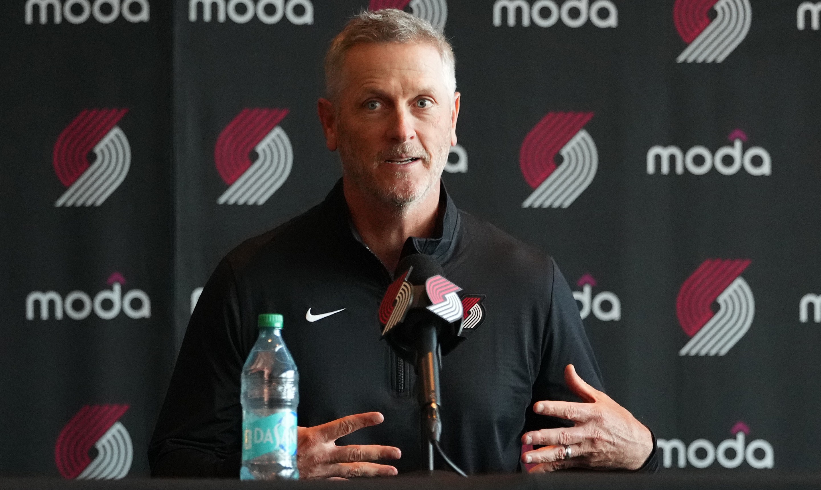 Tom Dundon, Portland Trail Blazers owner (C), speaks as alternate governors Sheel Tyle (L) and Andrew Cherng (R) listen during a press conference before a game against the New Orleans Pelicans at Moda Center on April 02, 2026 in Portland, Oregon. NOTE TO USER: User expressly acknowledges and agrees that, by downloading and or using this photograph, User is consenting to the terms and conditions of the Getty Images License Agreement. (Photo by Soobum Im/Getty Images)