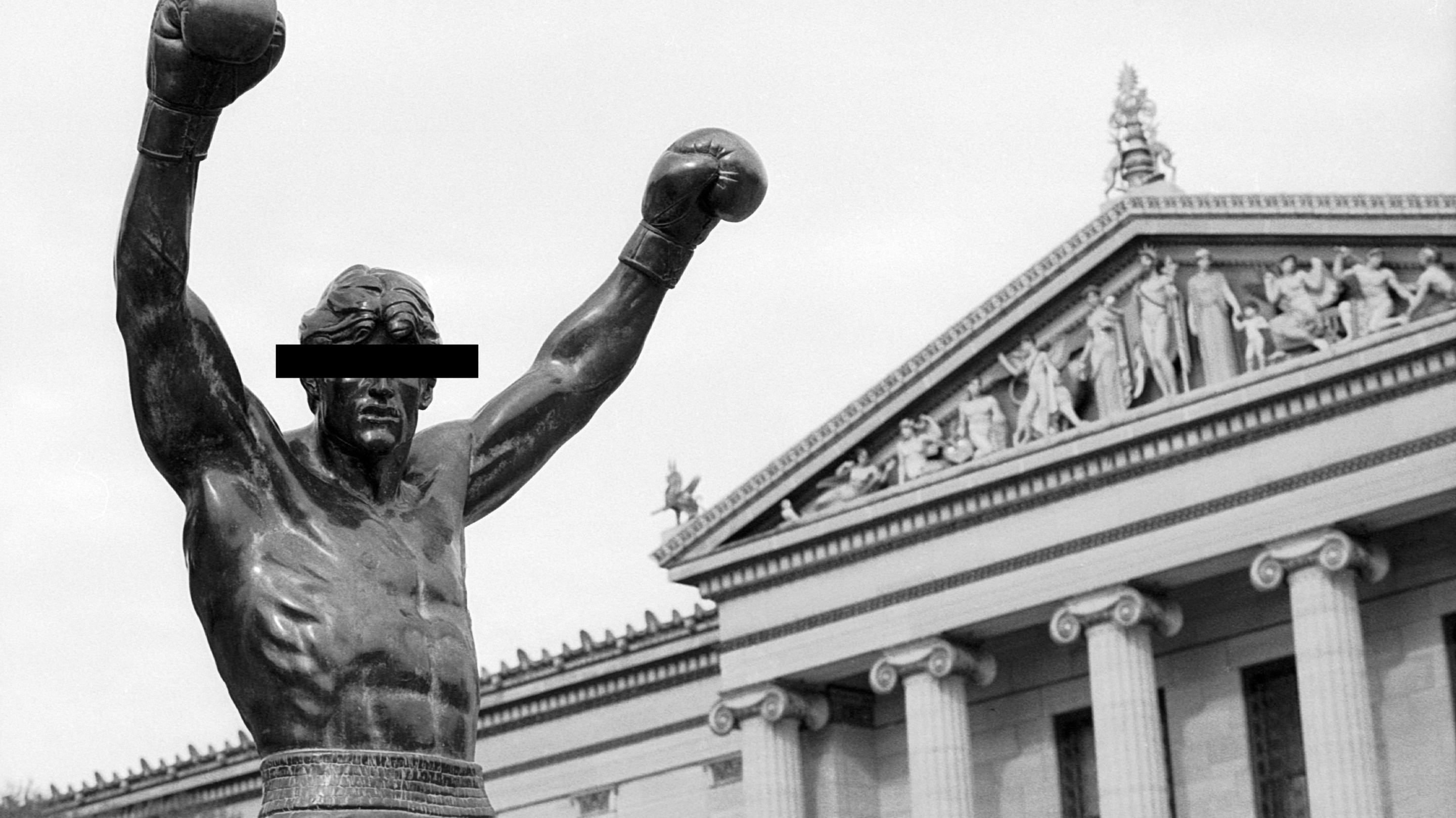 PHILADELPHIA, PENNSYLVANIA - CIRCA 1990: The Rocky statue stands atop the Philadelphia Museum of Art steps in Philadelphia, Pennsylvania in 1990. The statue of fictional character Rocky Balboa, as portrayed by actor Sylvester Stallone, was created for and used in the Rocky III movie. It was later located outside the Spectrum at the South Philadelphia Sports Complex. In 1990, it was temporarily moved to the top of the museum steps, which feature prominently in the original Rocky film, for the filming of Rocky V. In 2006, the statue was moved to a grassy area at street level on museum grounds. (Photo by James Drake/Getty Images)