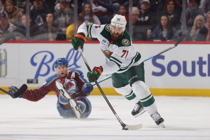 Nick Foligno #71 of the Minnesota Wild skates against Nathan MacKinnon