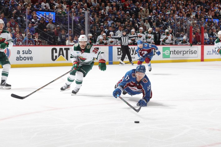 Parker Kelly #17 of the Colorado Avalanche dives for a puck against Mats Zuccarello