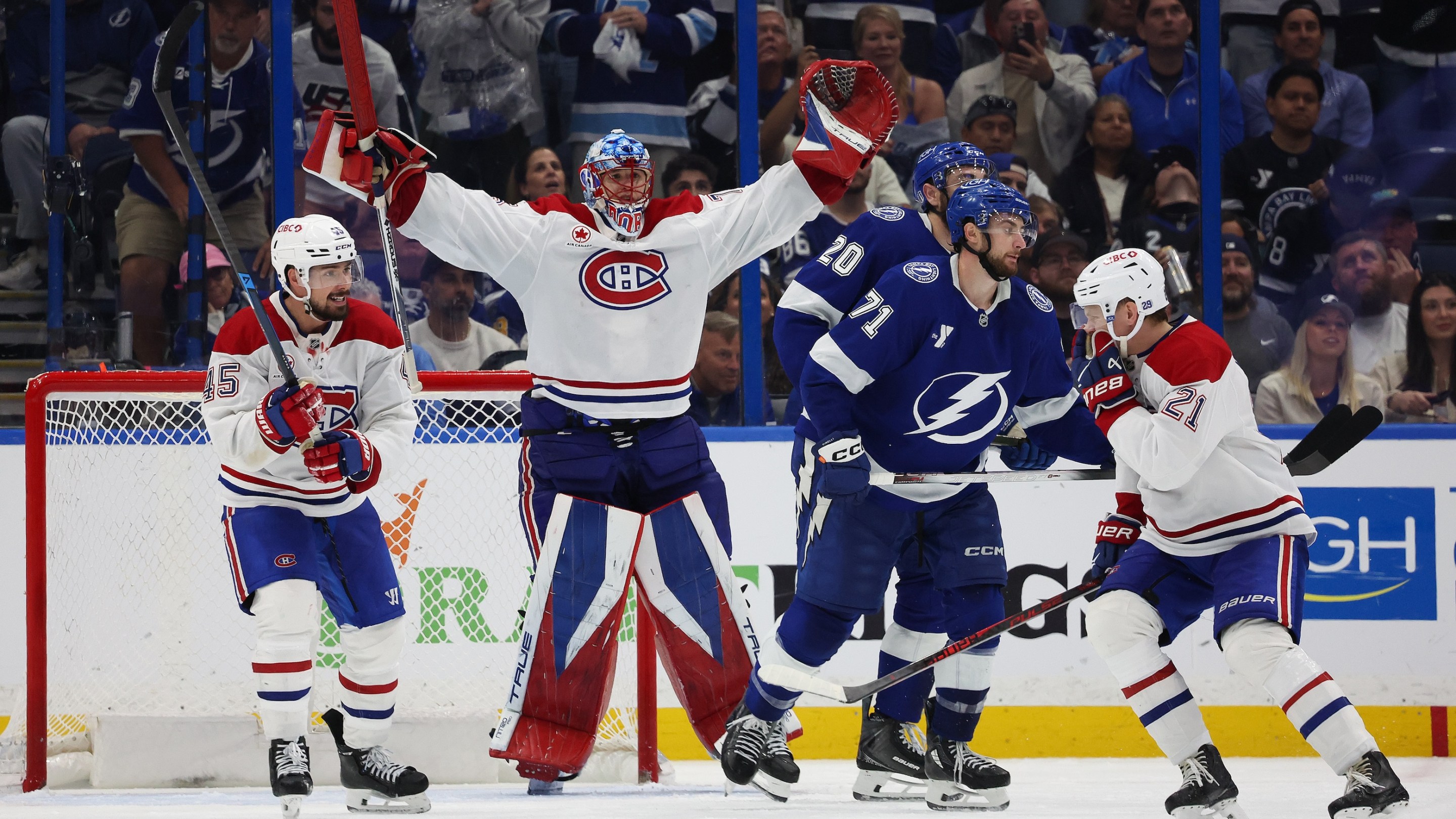 Jakub Dobes #75, Alexandre Carrier #45 and Kaiden Guhle #21 of the Montréal Canadiens celebrate after defeating the Tampa Bay Lightning 2-1 in Game Seven of the First Round of the 2026 Stanley Cup Playoffs on May 3, 2026.