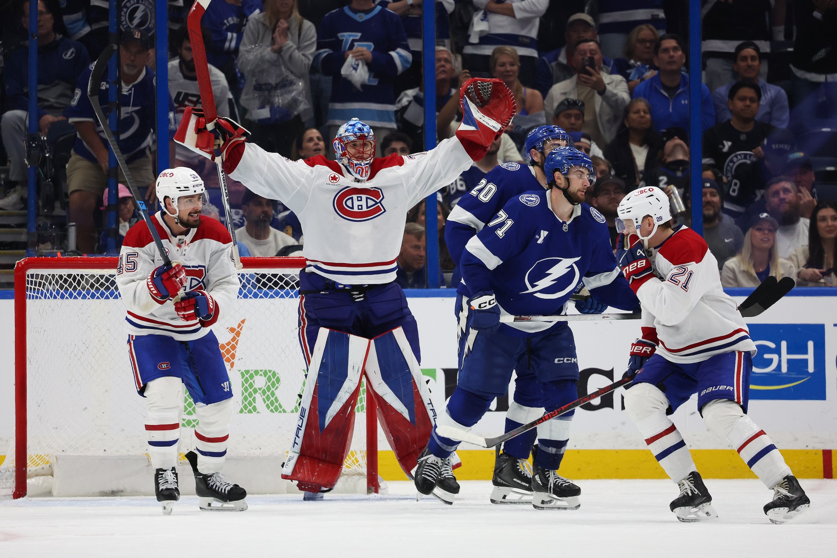 Jakub Dobes #75, Alexandre Carrier #45 and Kaiden Guhle #21 of the Montréal Canadiens celebrate after defeating the Tampa Bay Lightning 2-1 in Game Seven of the First Round of the 2026 Stanley Cup Playoffs on May 3, 2026.