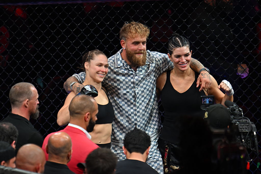 Gina Carano and Ronda Rousey pose with Jake Paul