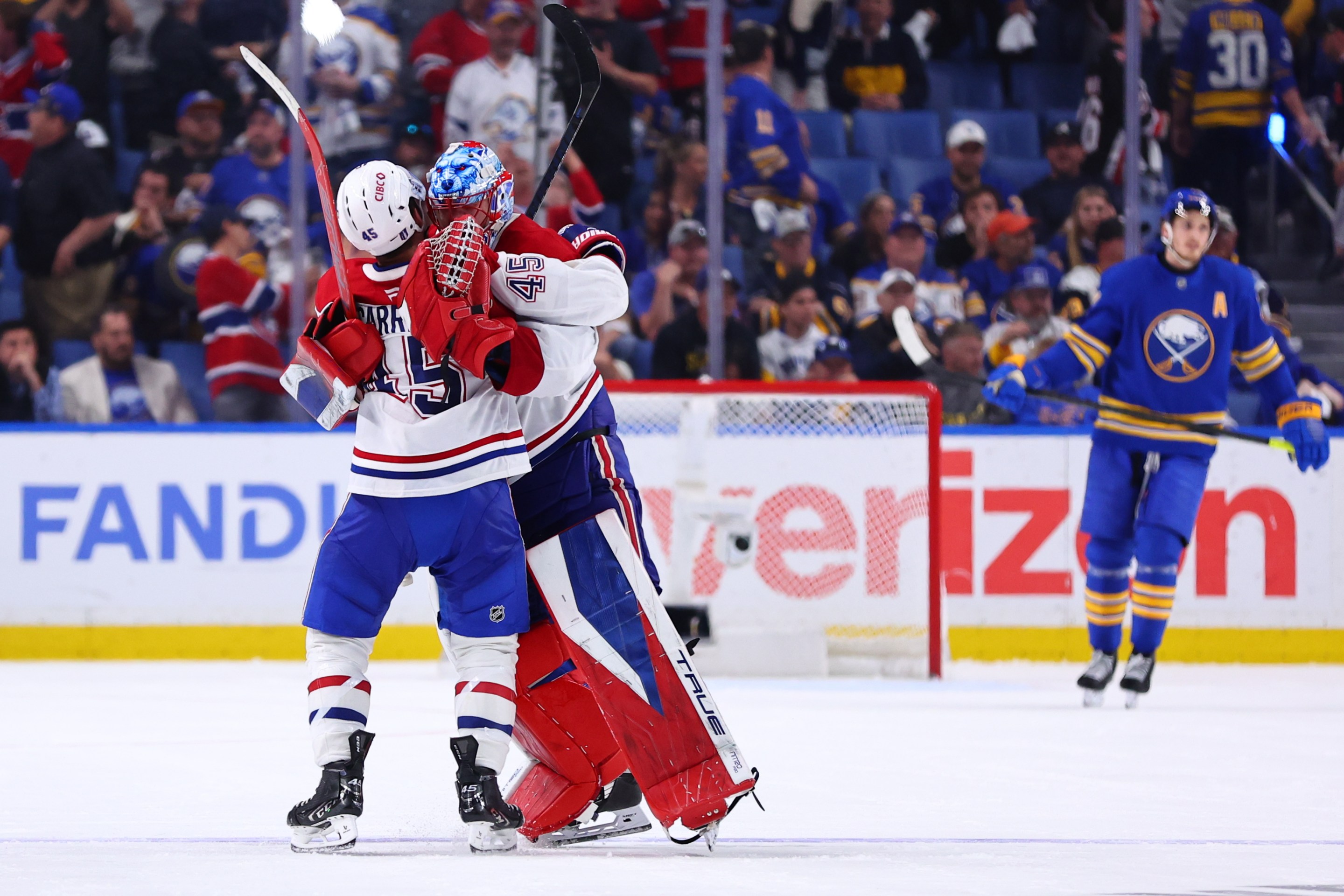 Jakub Dobes #75 of the Montreal Canadiens is congratulated by Alexandre Carrier #45 of the Montreal Canadiens