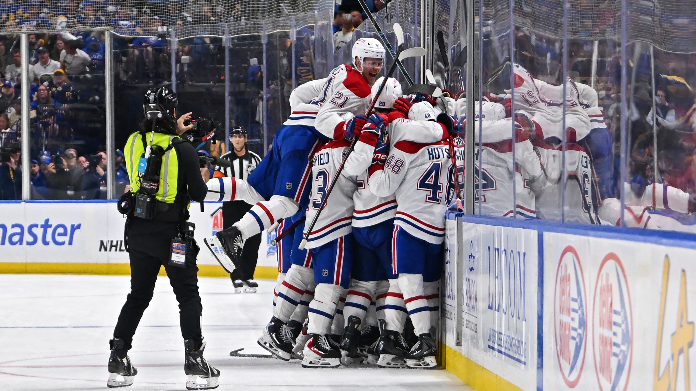 BUFFALO, NEW YORK - MAY 18: Alex Newhook #15 of the Montréal Canadiens celebrates with teammates after scoring a goal against the Buffalo Sabres during overtime in Game Seven of the Second Round of the 2026 Stanley Cup Playoffs at KeyBank Center on May 18, 2026 in Buffalo, New York. (Photo by Joe Hrycych/Getty Images)