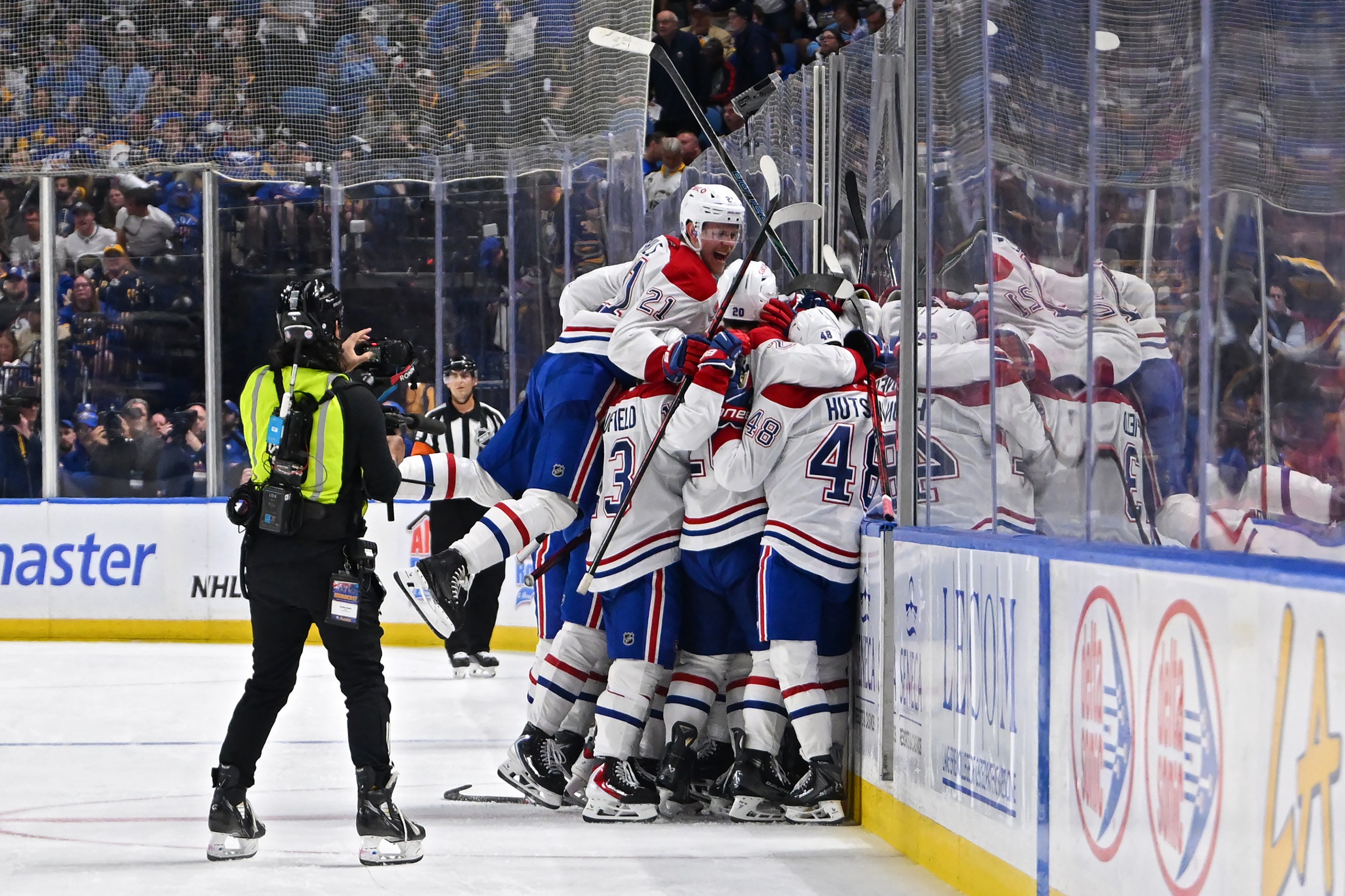 BUFFALO, NEW YORK - MAY 18: Alex Newhook #15 of the Montréal Canadiens celebrates with teammates after scoring a goal against the Buffalo Sabres during overtime in Game Seven of the Second Round of the 2026 Stanley Cup Playoffs at KeyBank Center on May 18, 2026 in Buffalo, New York. (Photo by Joe Hrycych/Getty Images)
