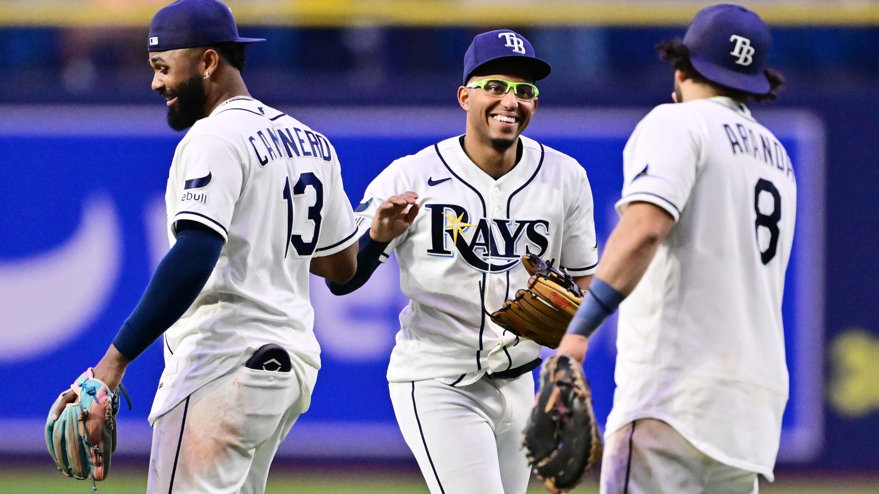 Junior Caminero #13, Richie Palacios #1 and Jonathan Aranda #8 of the Tampa Bay Rays celebrate after defeating the Baltimore Orioles 16-6 at Tropicana Field on May 18, 2026 in St Petersburg, Florida.