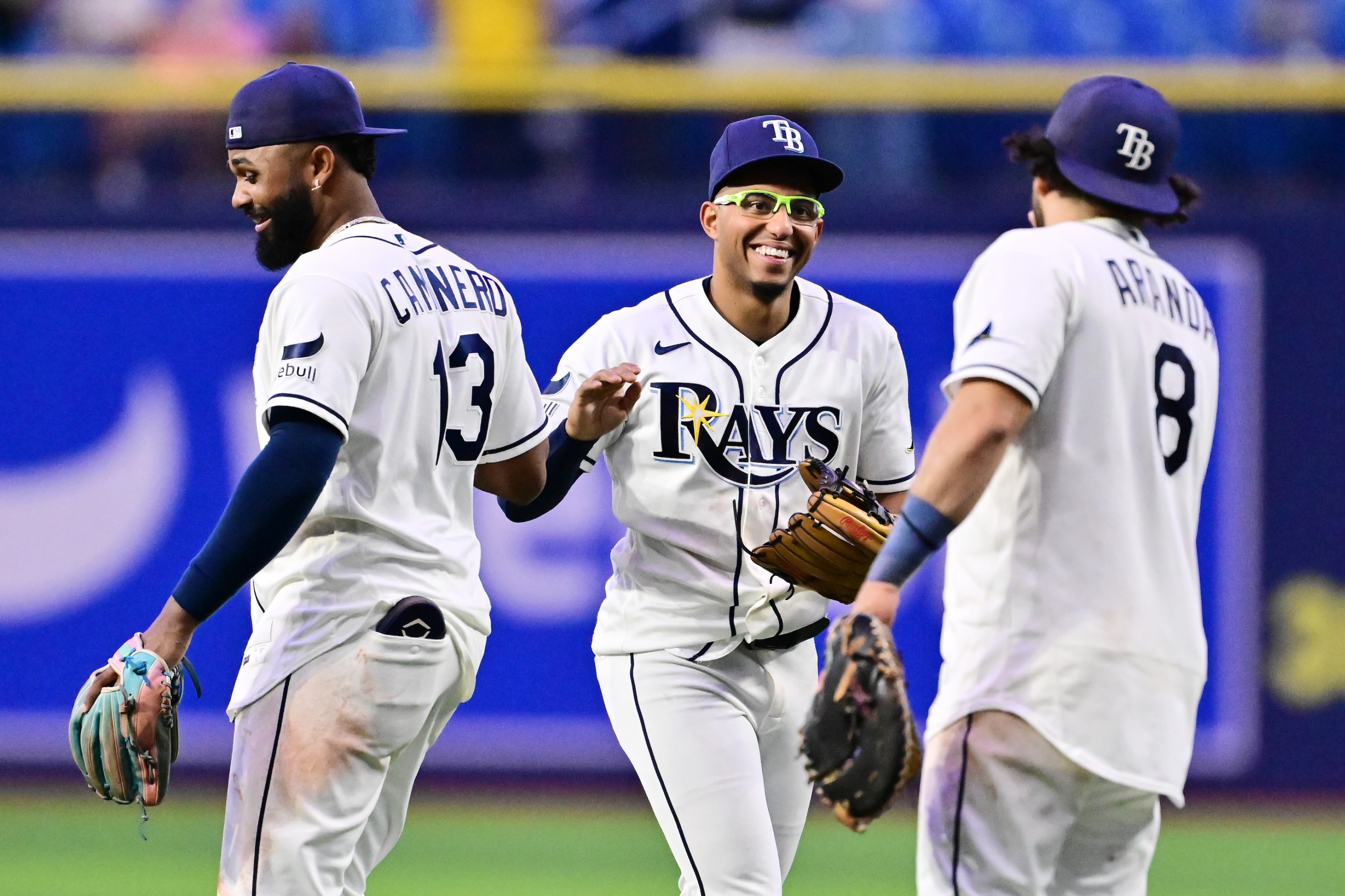Junior Caminero #13, Richie Palacios #1 and Jonathan Aranda #8 of the Tampa Bay Rays celebrate after defeating the Baltimore Orioles 16-6 at Tropicana Field on May 18, 2026 in St Petersburg, Florida.