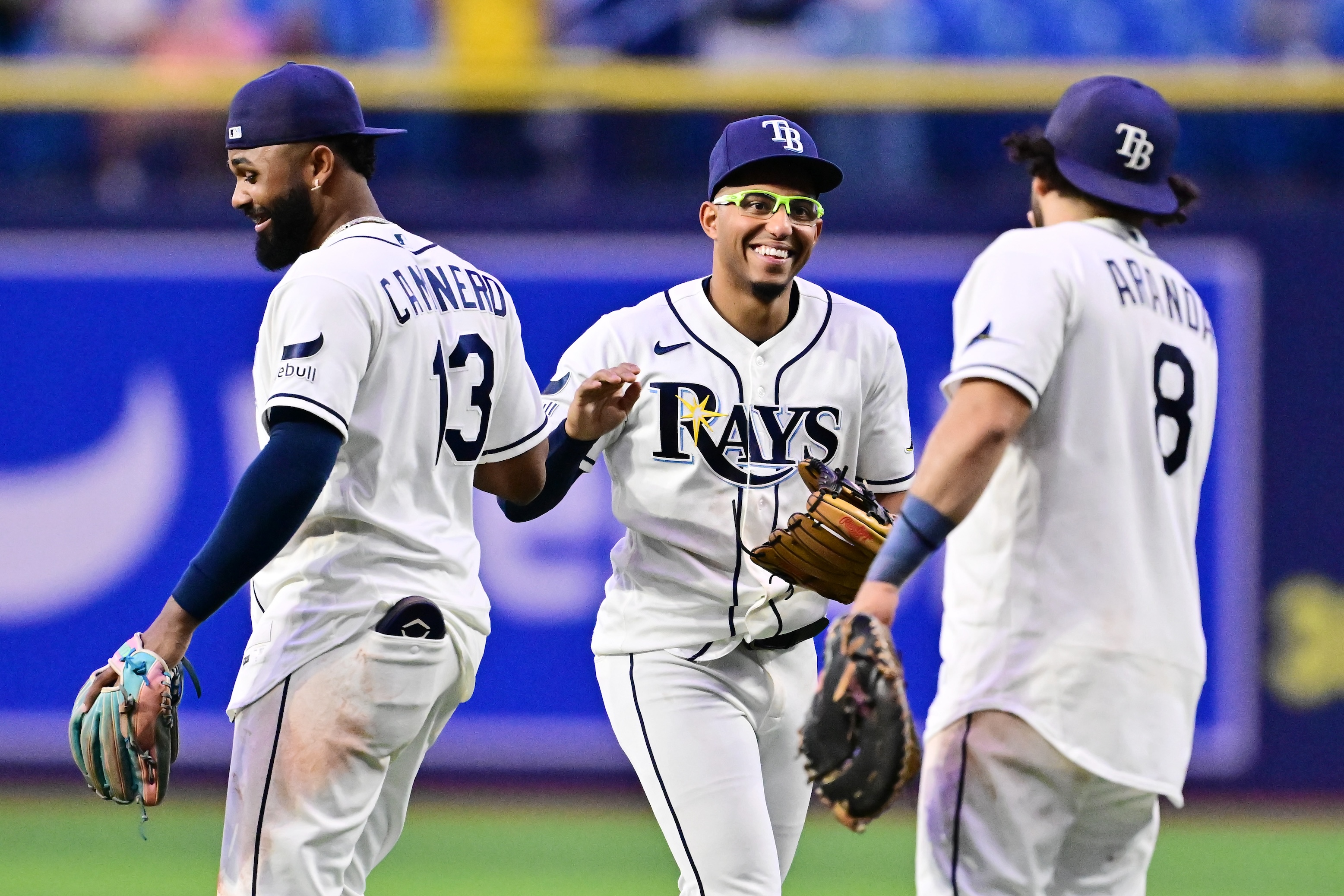 Junior Caminero #13, Richie Palacios #1 and Jonathan Aranda #8 of the Tampa Bay Rays celebrate after defeating the Baltimore Orioles 16-6 at Tropicana Field on May 18, 2026 in St Petersburg, Florida.