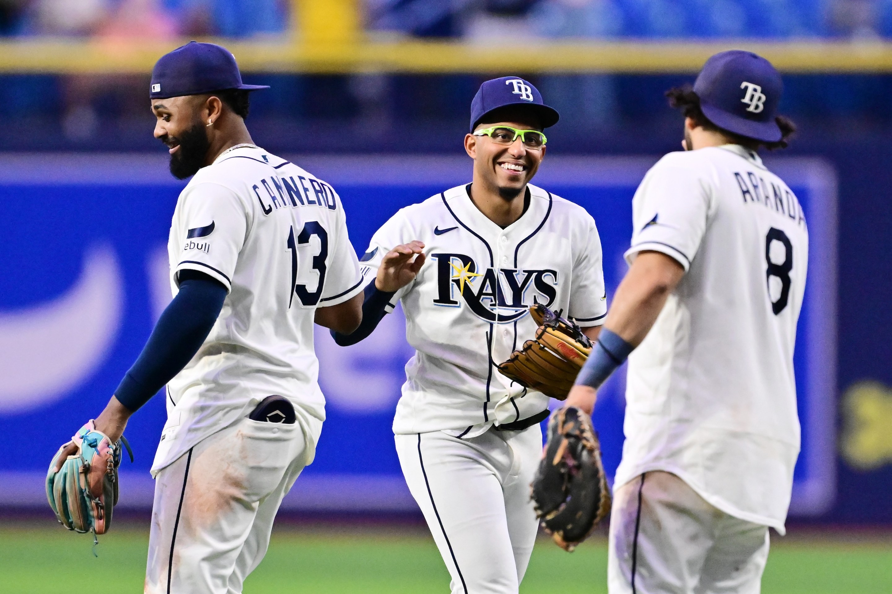 Junior Caminero #13, Richie Palacios #1 and Jonathan Aranda #8 of the Tampa Bay Rays celebrate after defeating the Baltimore Orioles 16-6 at Tropicana Field on May 18, 2026 in St Petersburg, Florida.