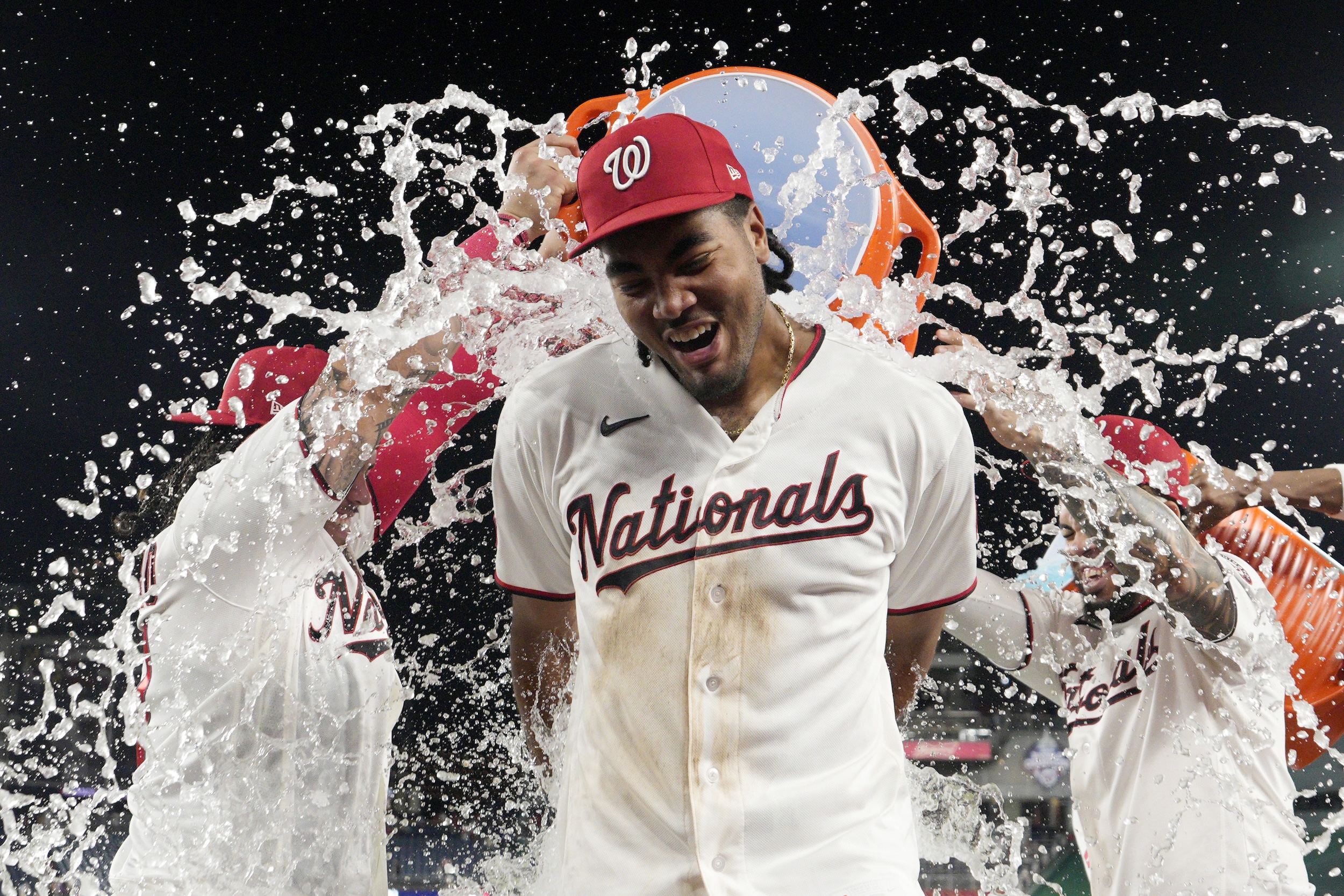 James Wood is drenched in water after a Nationals win.