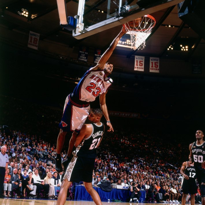 Marcus Camby #23 of the New York Knicks dunks over Tim Duncan #21 of the San Antonio Spurs during Game 4 of the NBA Finals June 23, 1999 at Madison Square Garden in New York, New York. NOTE TO USER: User expressly acknowledges that, by downloading and or using this photograph, User is consenting to the terms and conditions of the Getty Images License agreement. Mandatory Copyright Notice: Copyright 1993 NBAE (Photo by Nathaniel S. Butler/NBAE via Getty Images)