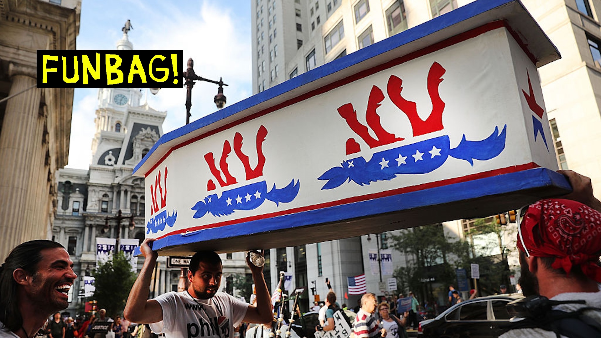 Protestors carry a coffin with an upside-down democratic party logo on it