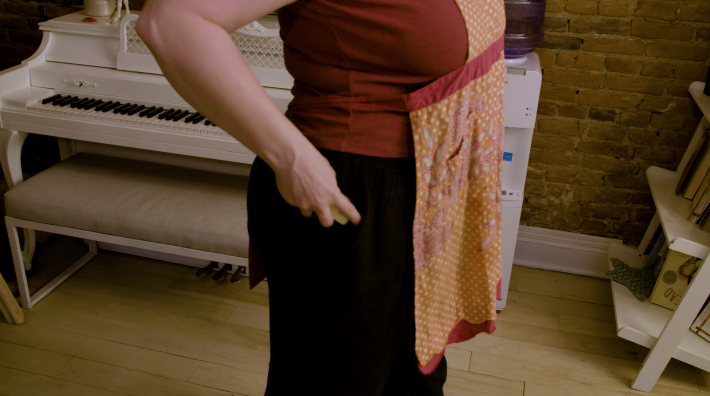 Anna puts sticks of butter into her pockets.