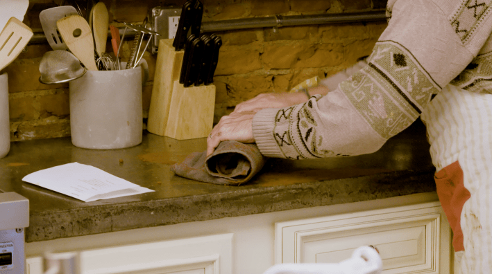 Rolling up a sponge inside a hand towel.