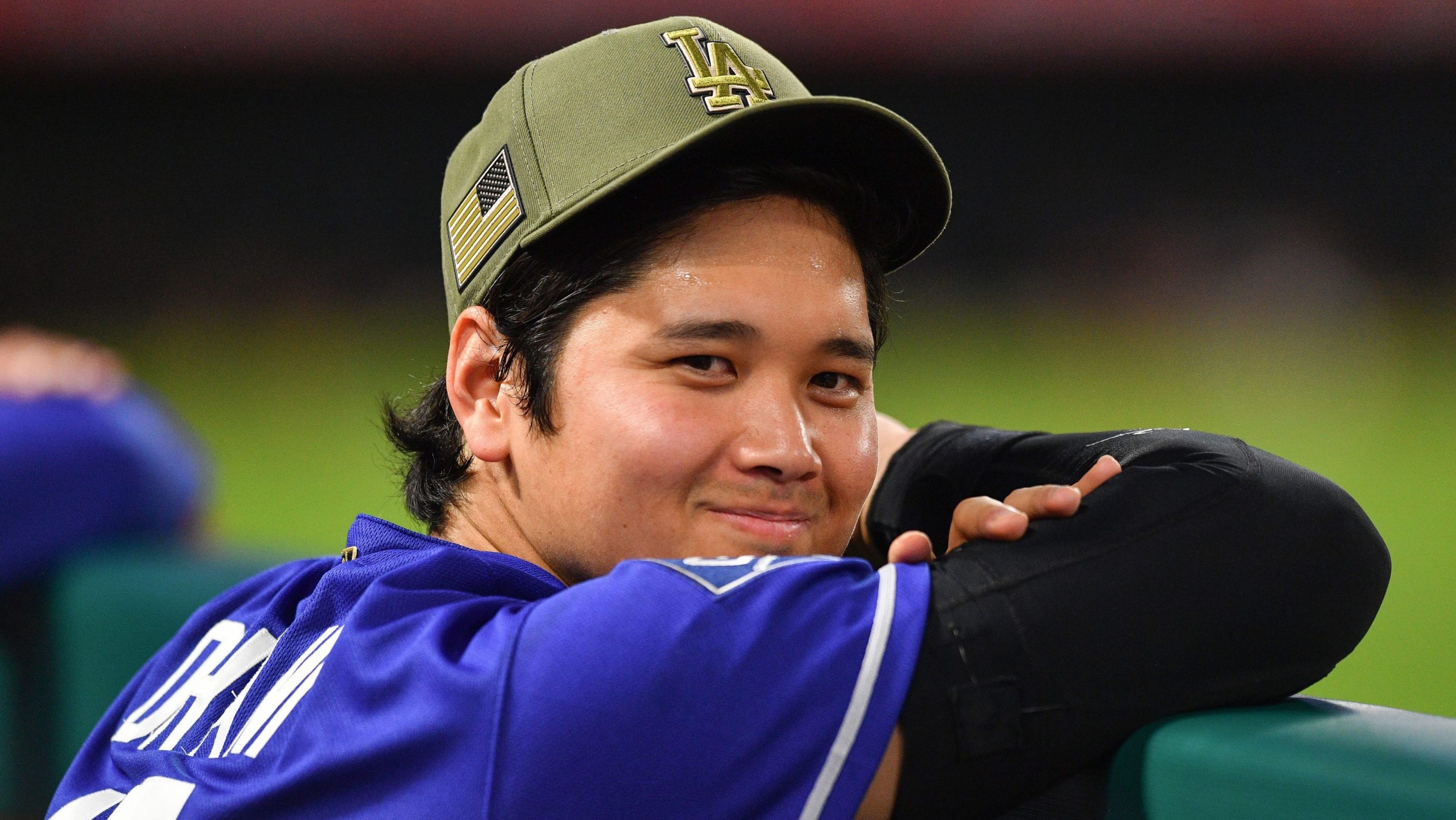 Los Angeles Dodgers designated hitter Shohei Ohtani (17) looks on in the dugout during the MLB game between the Los Angeles Dodgers versus the Los Angeles Angels on May 16, 2026 at Angel Stadium in Anaheim, CA. He has a smile on his face.