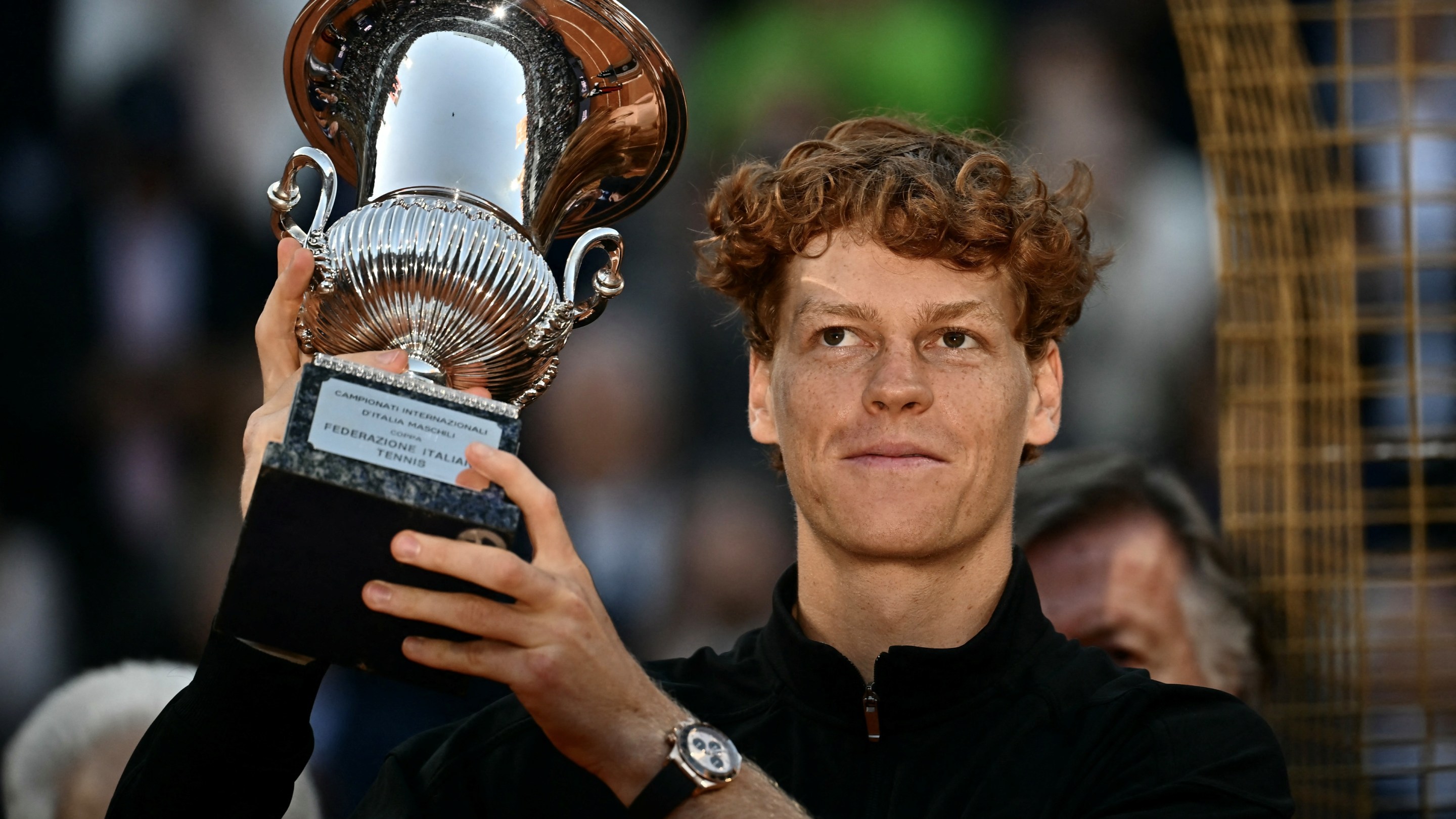 Italy's Jannik Sinner holds the trophy after winning the men's final of the ATP Rome Open tennis tournament.