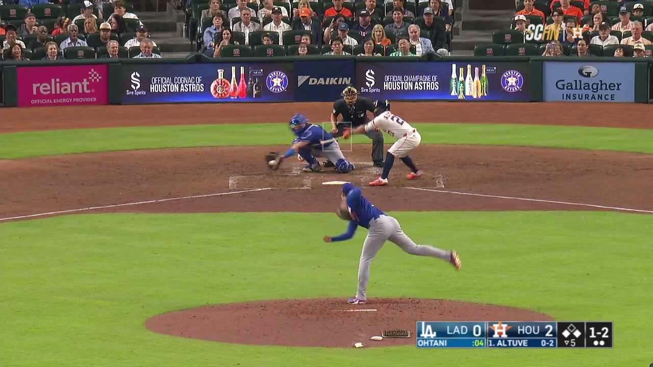 Jose Altuve takes a swing at a pitch over two feet off the plate.
