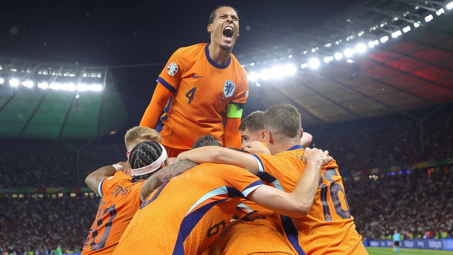 Teammates of Netherland celebrate the teams own goal from Mert Müldür of Türkiye to the 2:1 on the top of the grape Virgil van Dijk of Netherlands during the UEFA EURO 2024 quarter-final match between Netherlands and Türkiye at Olympiastadion on July 6, 2024 in Berlin, Germany