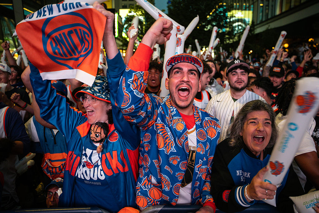 Knicks fans crowd around each other at a NBA playoffs watch party outside Madison Square Garden in spring 2026