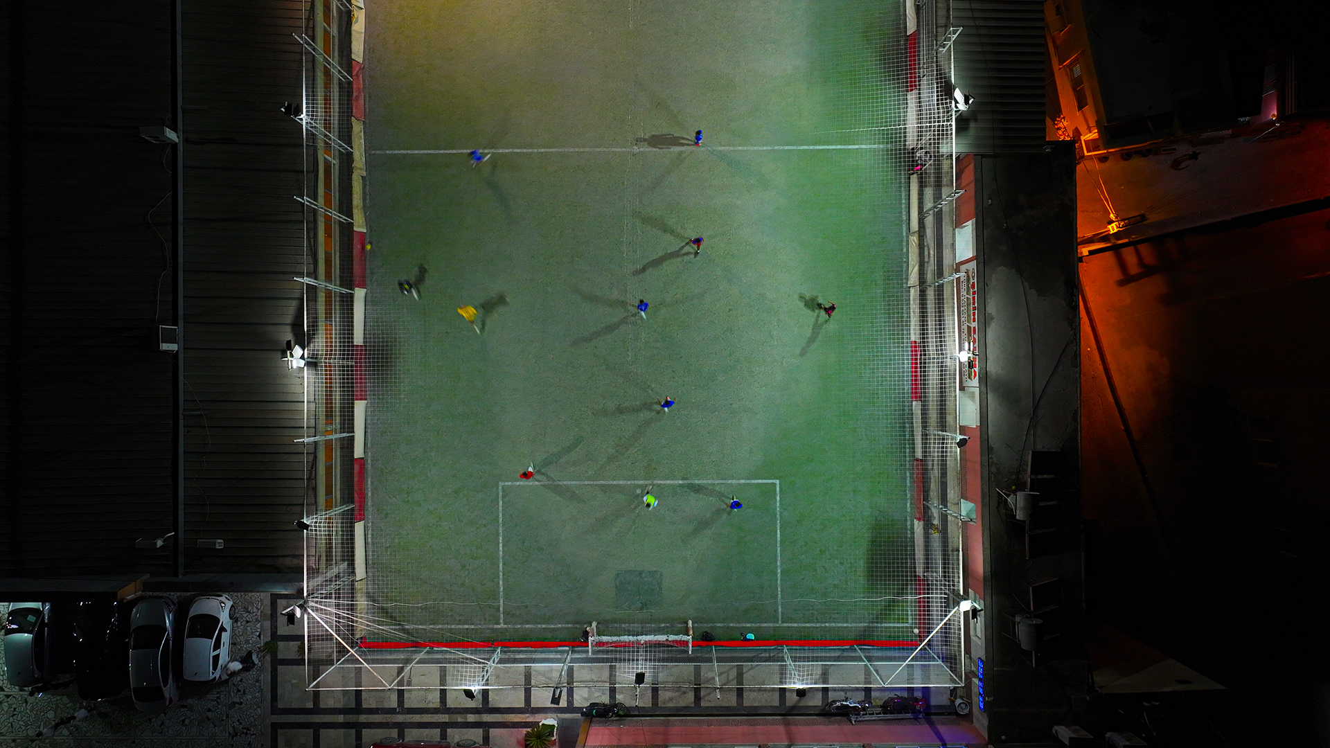 An aerial view of football players during a match on a soccer field built on the top of a 5-story building in Adana, Turkiye on August 20, 2025.
