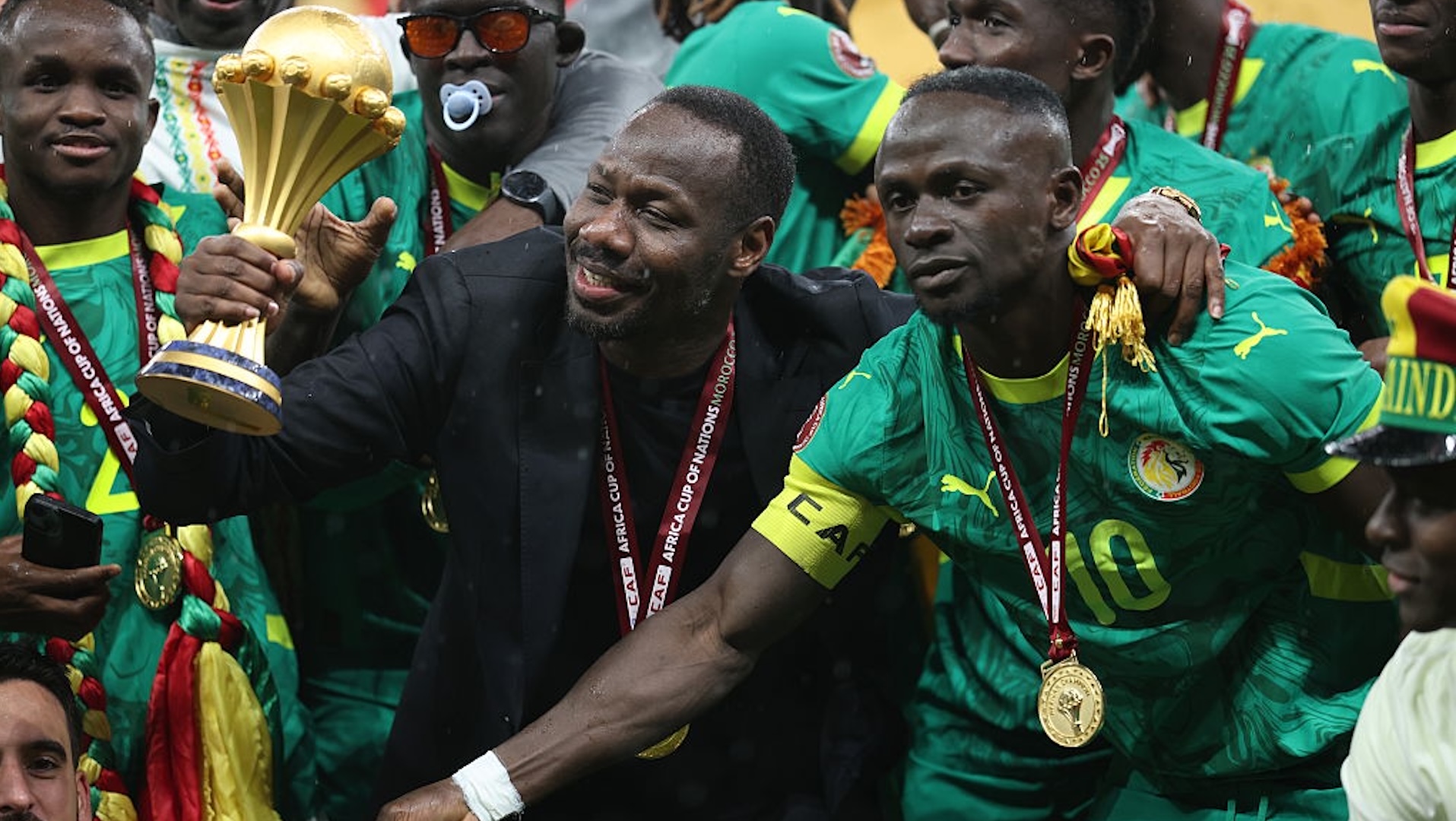 Sadio Mane and Pape Thiaw hold the AFCON trophy