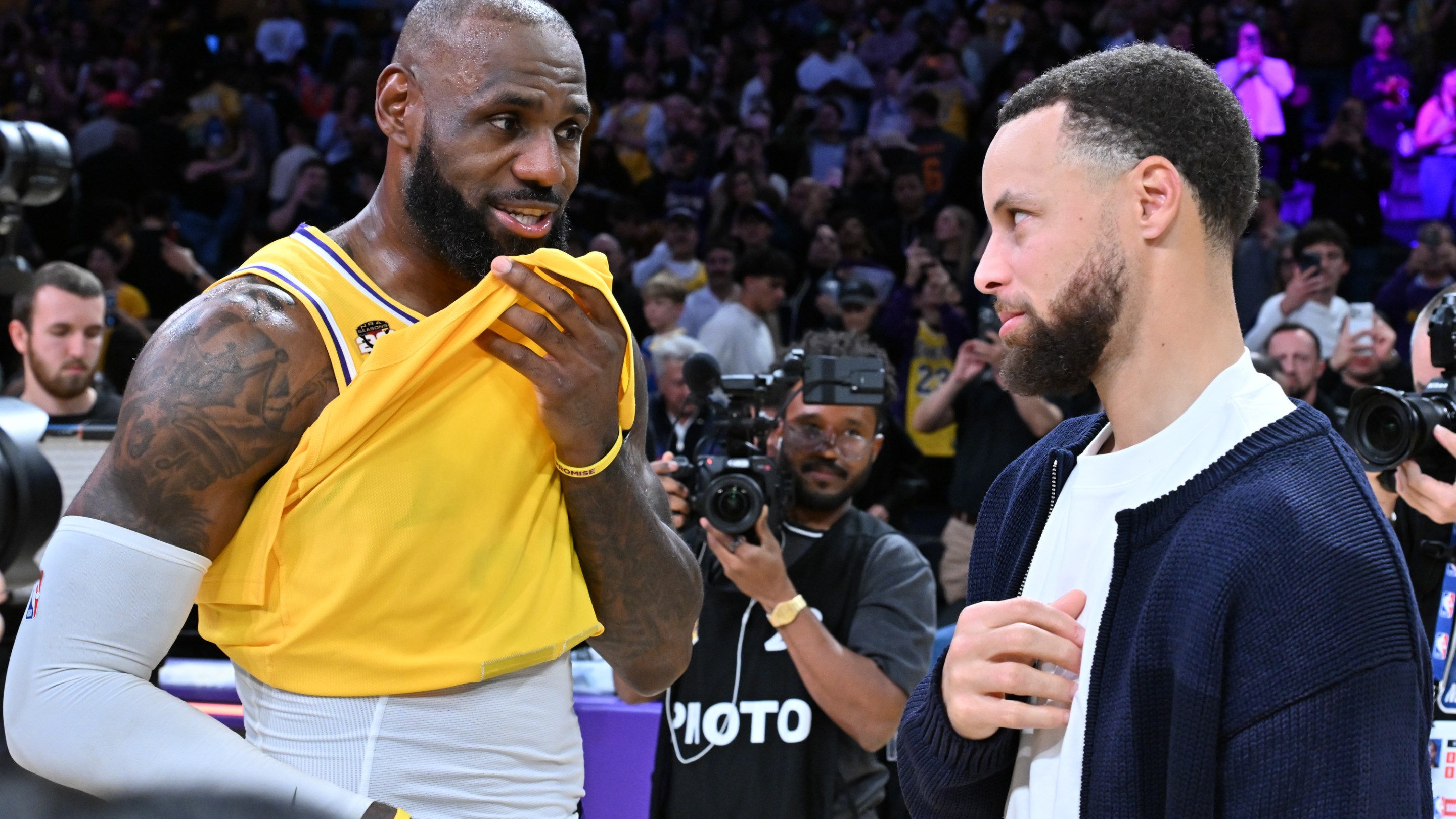LeBron James speaks with Stephen Curry following a basketball game between the Los Angeles Lakers and the Golden State Warriors