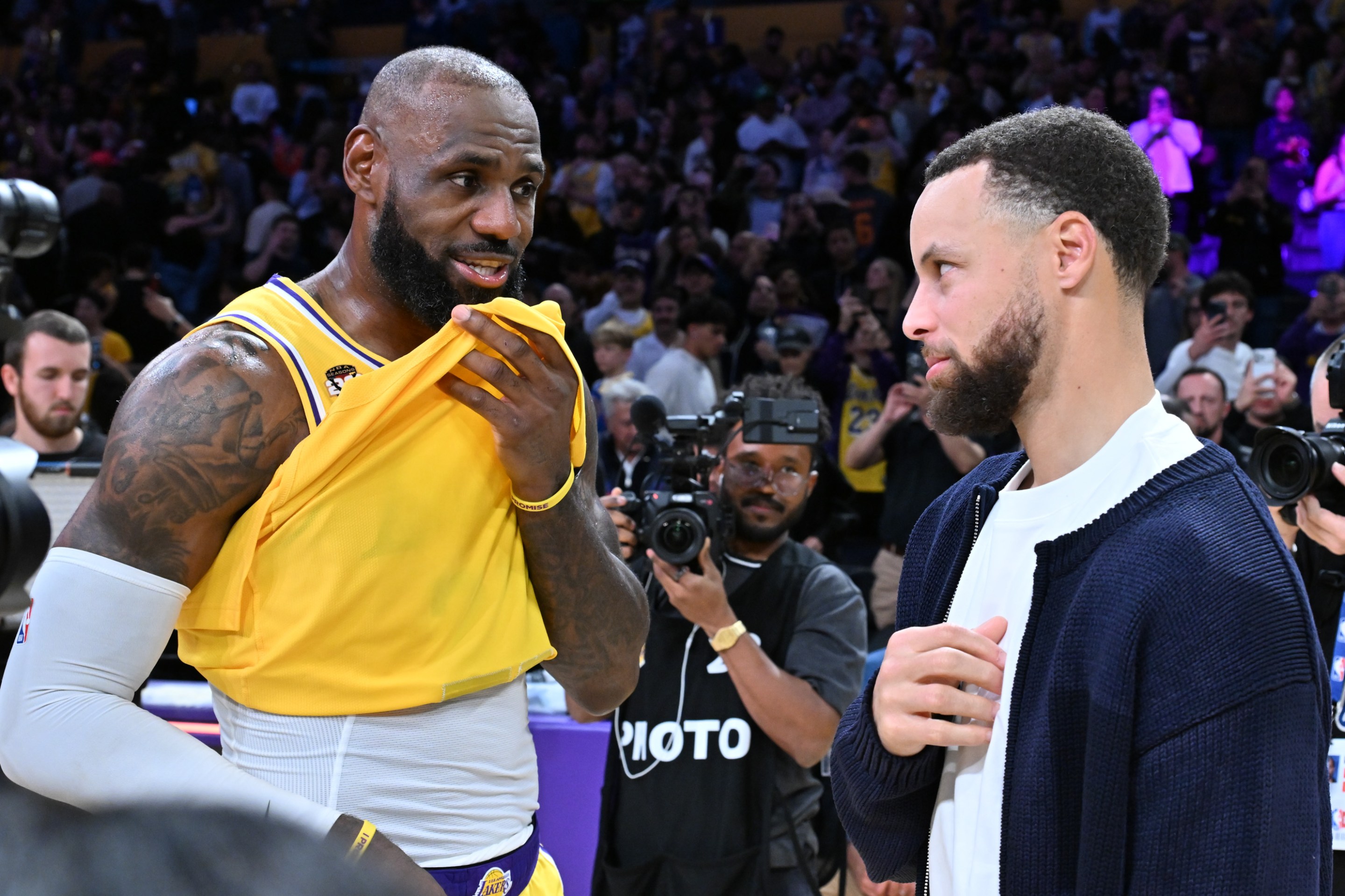 LeBron James speaks with Stephen Curry following a basketball game between the Los Angeles Lakers and the Golden State Warriors
