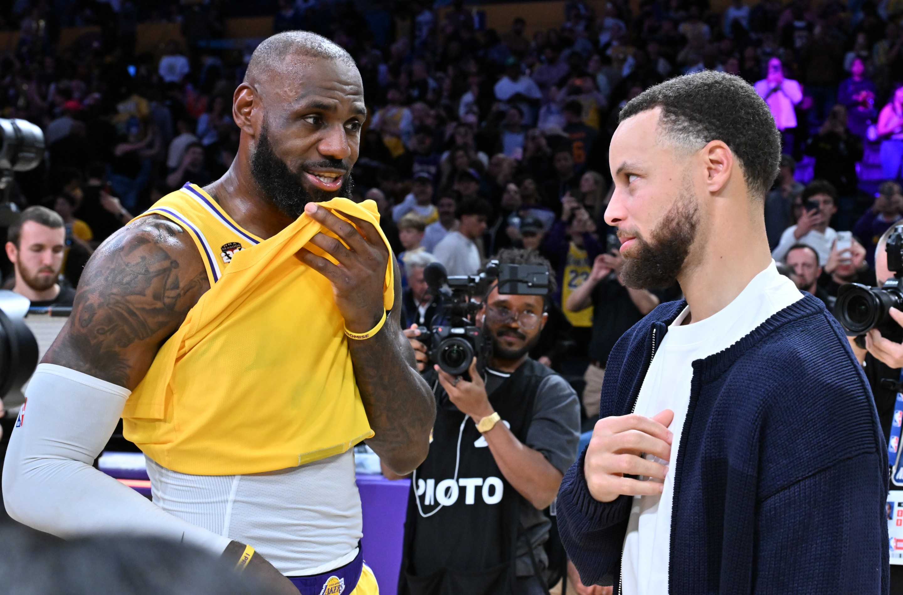 LeBron James speaks with Stephen Curry following a basketball game between the Los Angeles Lakers and the Golden State Warriors