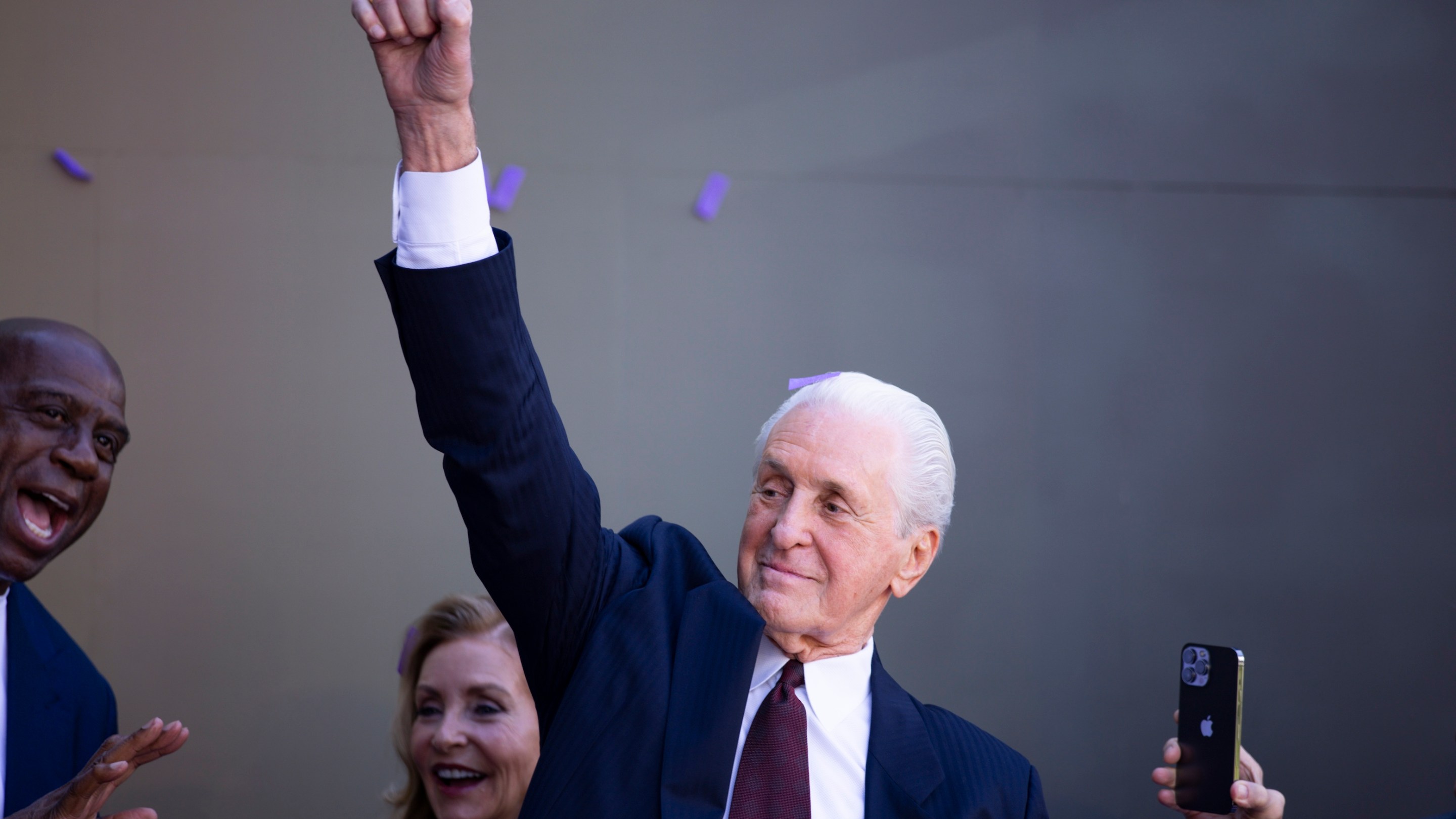 Pat Riley lifts his fist to imitate his statue after the reveal of the Pat Riley Lakers statue at Star Plaza outside the Lakers arena in February of 2026.