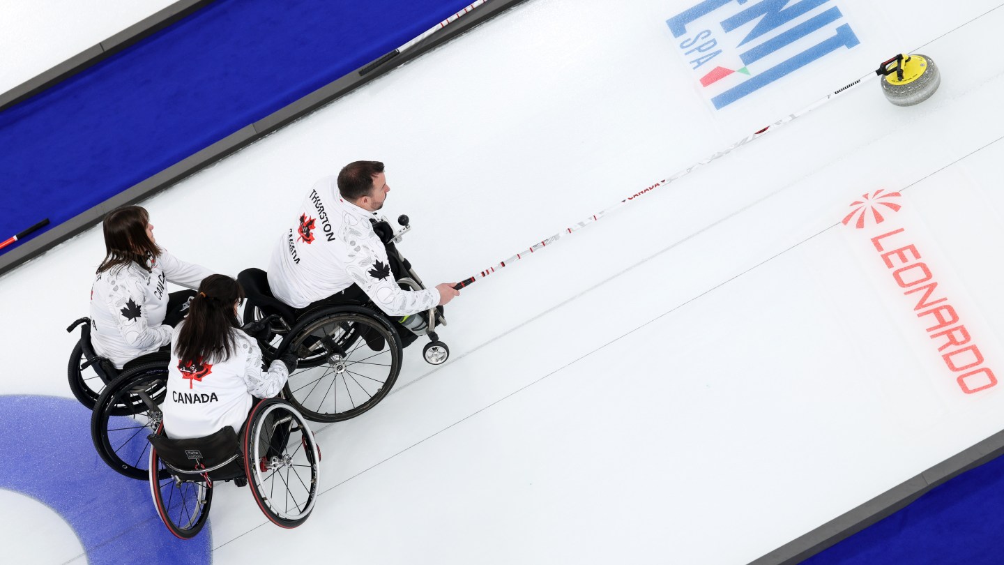 CORTINA D'AMPEZZO, ITALY - MARCH 14: Jon Thurston of Team Canada competes with teammates Ina Forrest and Collinda Joseph during the Wheelchair Curling Mixed Team Gold Medal game between Team People’s Republic of China and Team Canada on day eight of the Milano Cortina 2026 Winter Paralympic Games at Cortina Curling Olympic Stadium on March 14, 2026 in Cortina d'Ampezzo, Italy. (Photo by Mattia Ozbot/Getty Images)