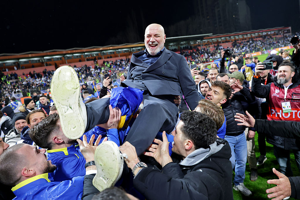 Bosnian players lift their coach, Sergej Barbarez, in celebration after they qualified for the 2026 World Cup.