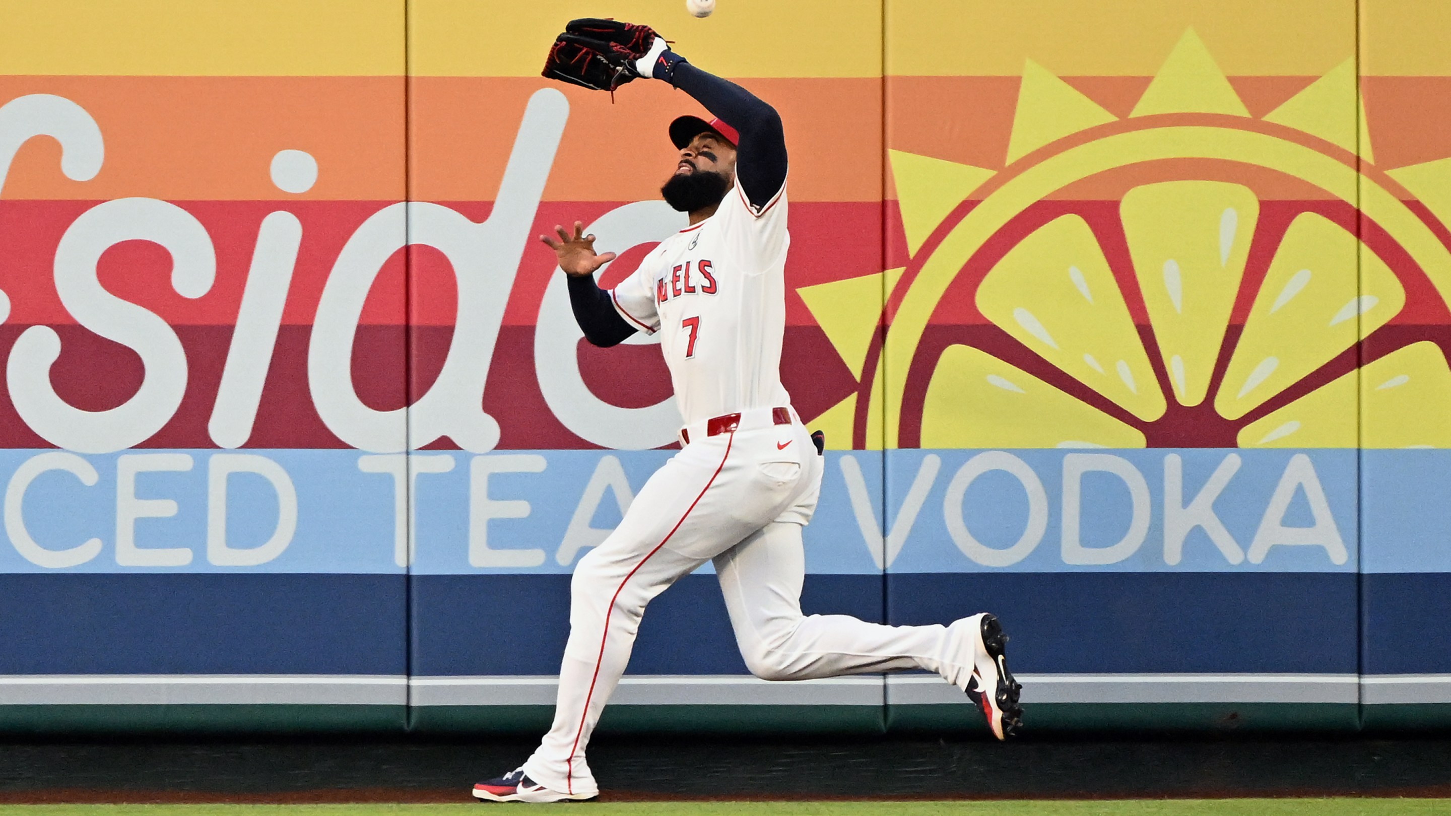 A fly ball bounces off the head of Los Angeles Angels right fielder Jo Adell