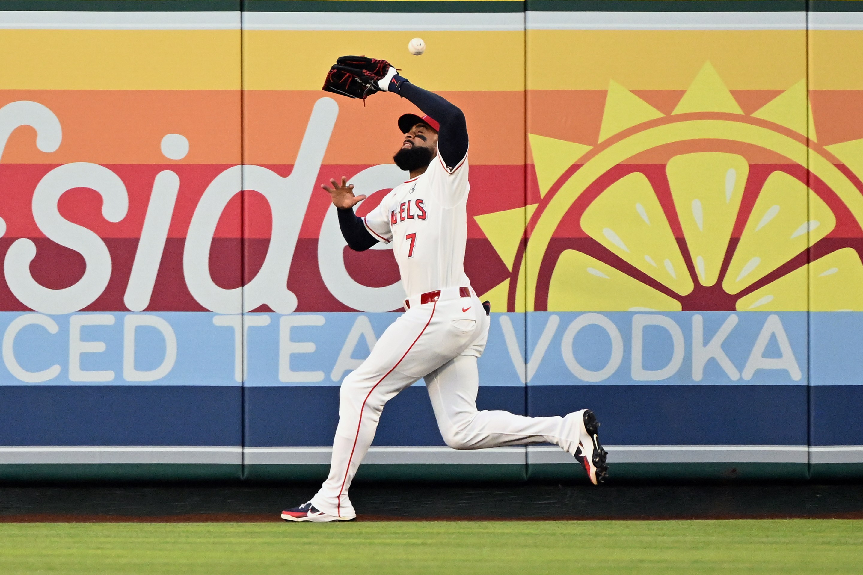 A fly ball bounces off the head of Los Angeles Angels right fielder Jo Adell