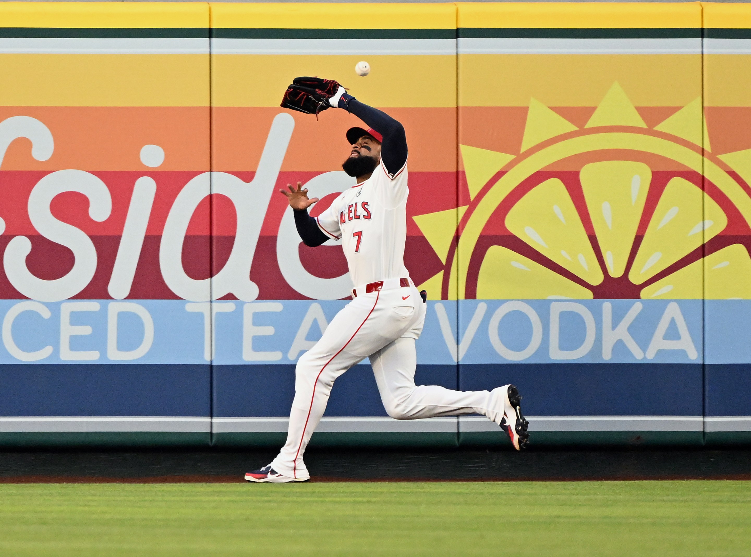 A fly ball bounces off the head of Los Angeles Angels right fielder Jo Adell