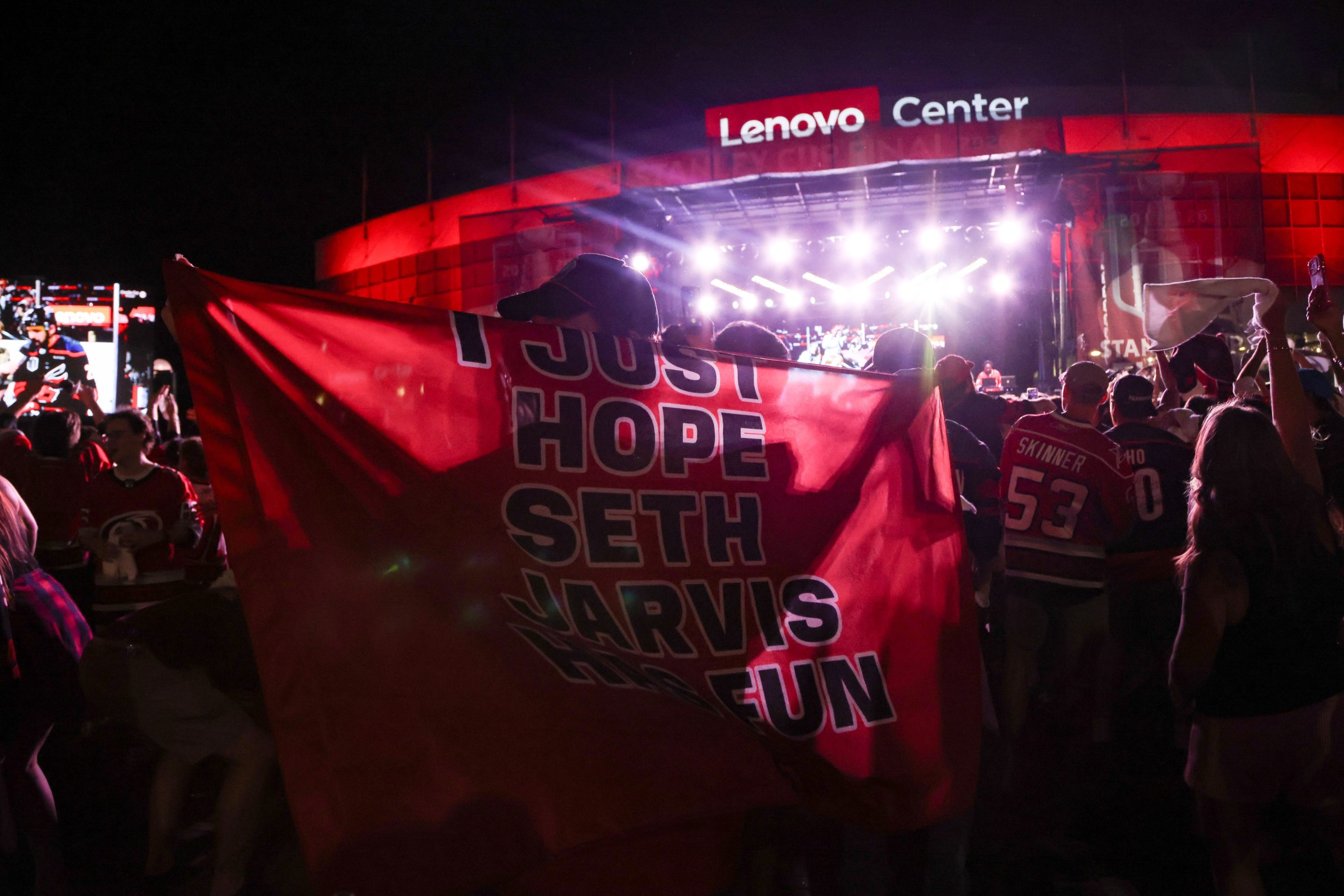 fan holds a cape reading "I just hope Seth Jarvis has fun" after game two of the Stanley Cup Finals on June 4, 2026 at Lenovo Arena
