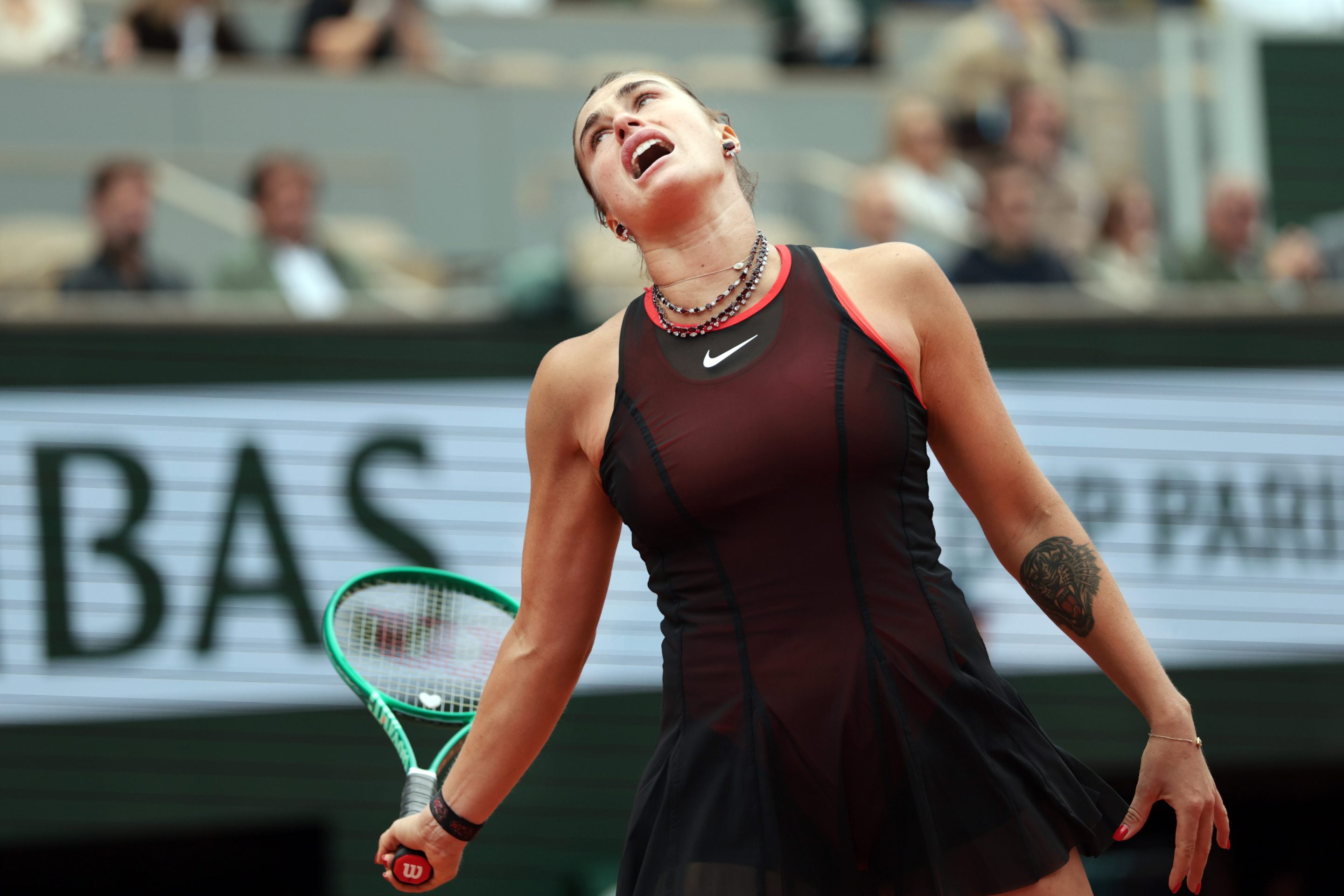 Aryna Sabalenka reacts as she is on the way to being defeated by Diana Shnaider