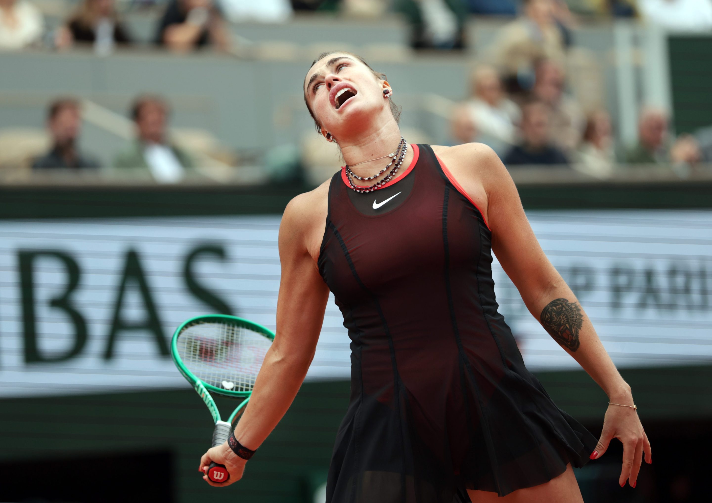 Aryna Sabalenka reacts as she is on the way to being defeated by Diana Shnaider