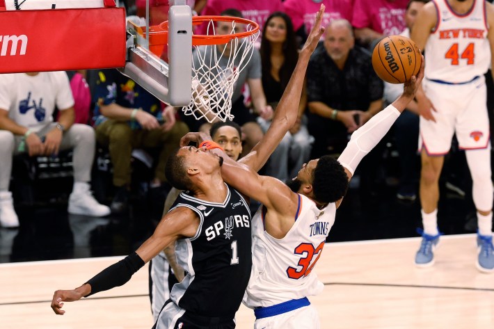 Karl-Anthony Towns attempts to shoot over Victor Wembanyama.