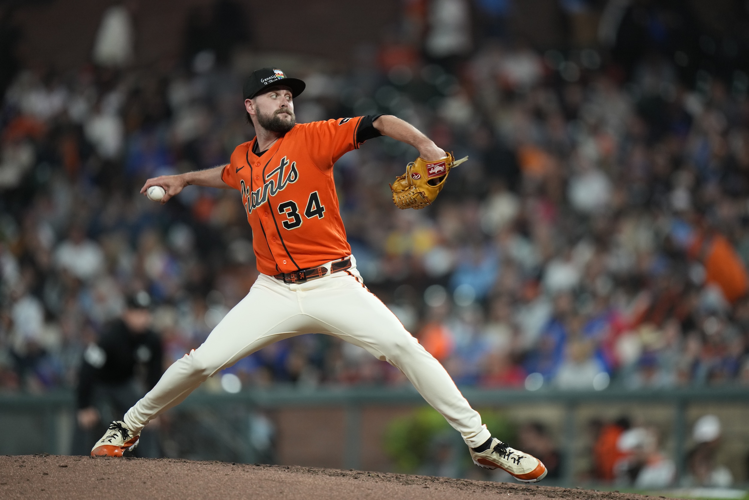 T Brubaker of the San Francisco Giants pitches with bible crap scrawled on his cap.
