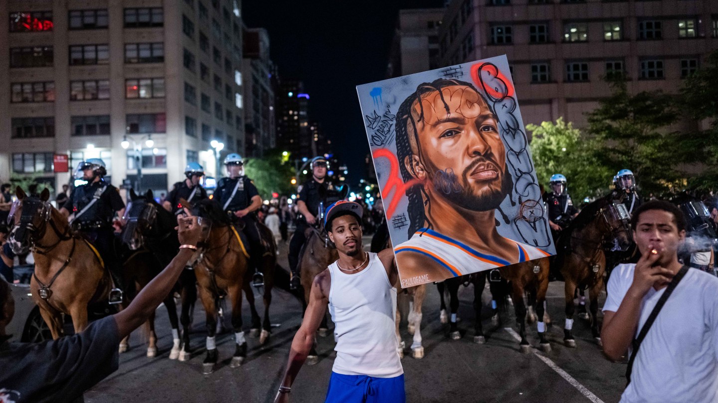 NEW YORK, NEW YORK - JUNE 13: A New York Knicks fan holds an image of Jalen Brunson as fans celebrate their win against San Antonio Spurs in Game 5 of the NBA Finals on June 13, 2026 in New York City. The New York Knicks lead the San Antonio Spurs 3-1 and could win the franchise's first NBA championship since 1973 if they win tonight.(Photo by Adam Gray/Getty Images)