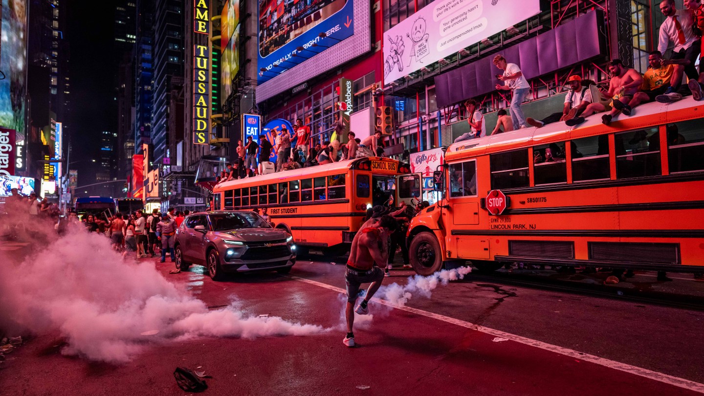 NEW YORK, NEW YORK - JUNE 14: A person kicks a smoke canister as New York Knicks fans celebrate their win against San Antonio Spurs in Game 5 of the NBA Finals in Times Square on June 14, 2026 in New York City. The New York Knicks lead the San Antonio Spurs 3-1 and could win the franchise's first NBA championship since 1973 if they win tonight.(Photo by Adam Gray/Getty Images)